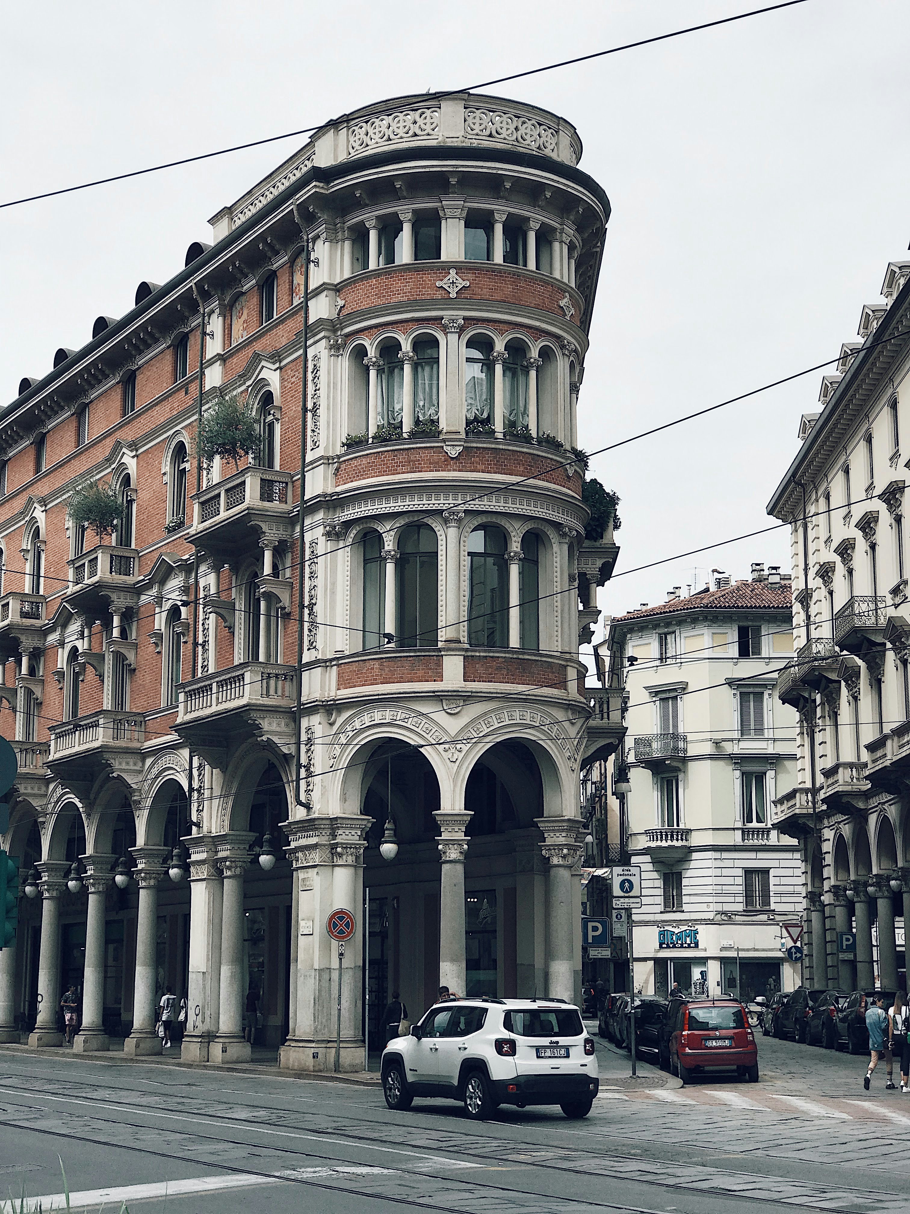 A car driving down a street next to tall buildings