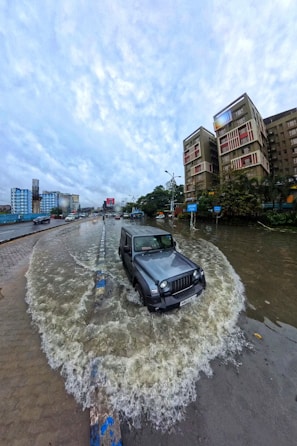 A car is parked in the middle of a flooded street