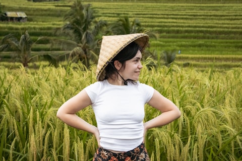 A woman standing in a field with her hands on her hips