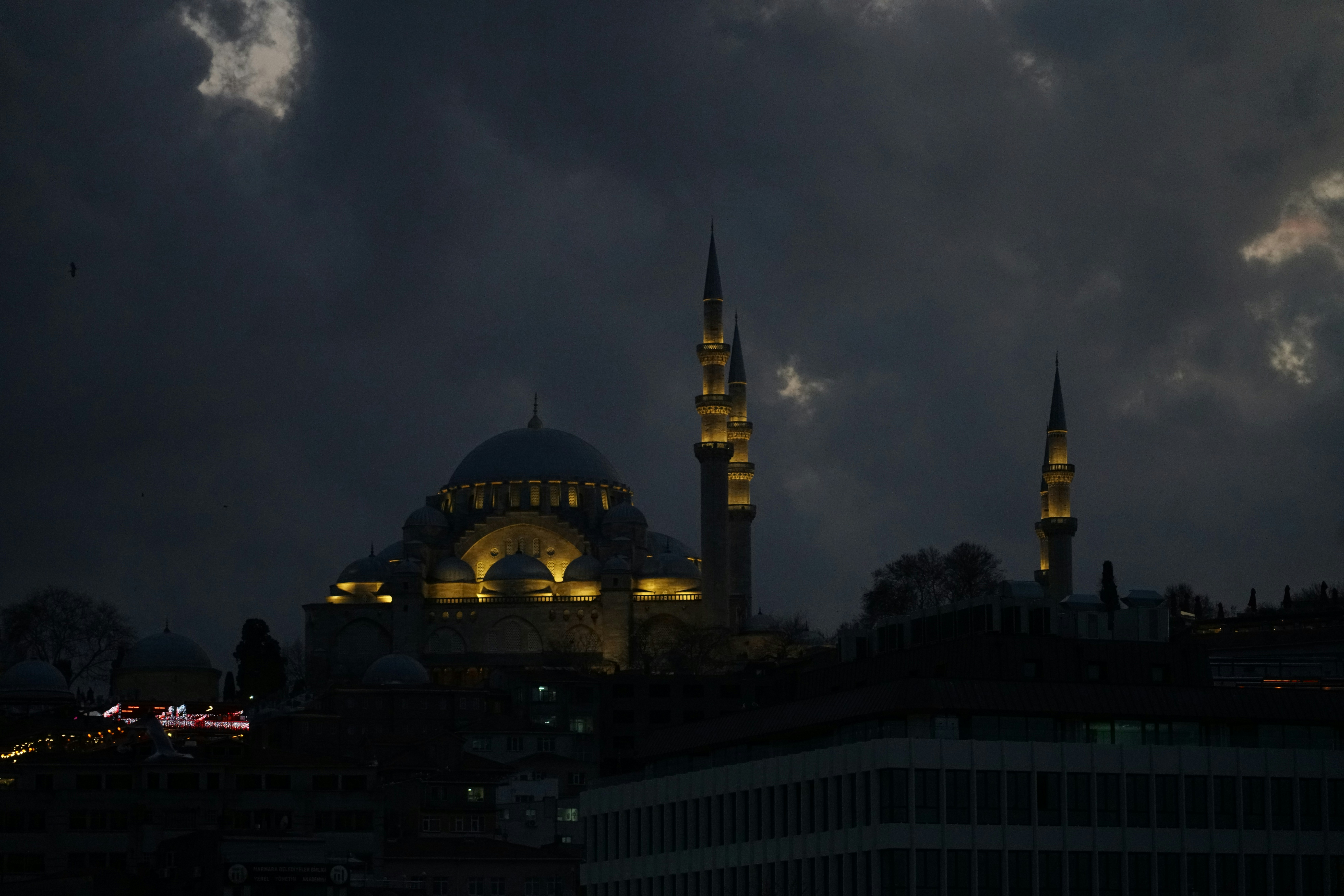 A night view of a large building with a sky background