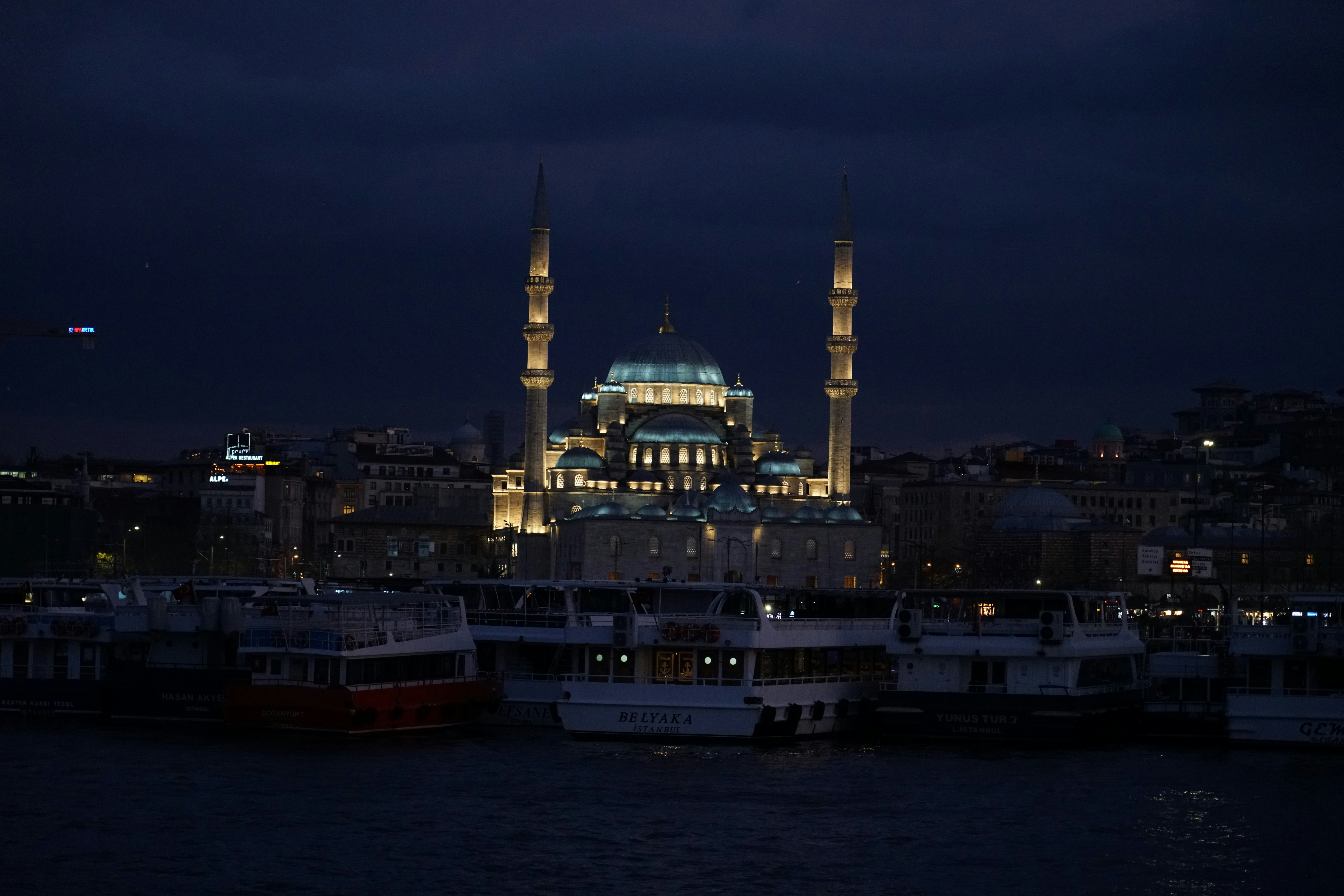 A night view of a city with a large building in the background