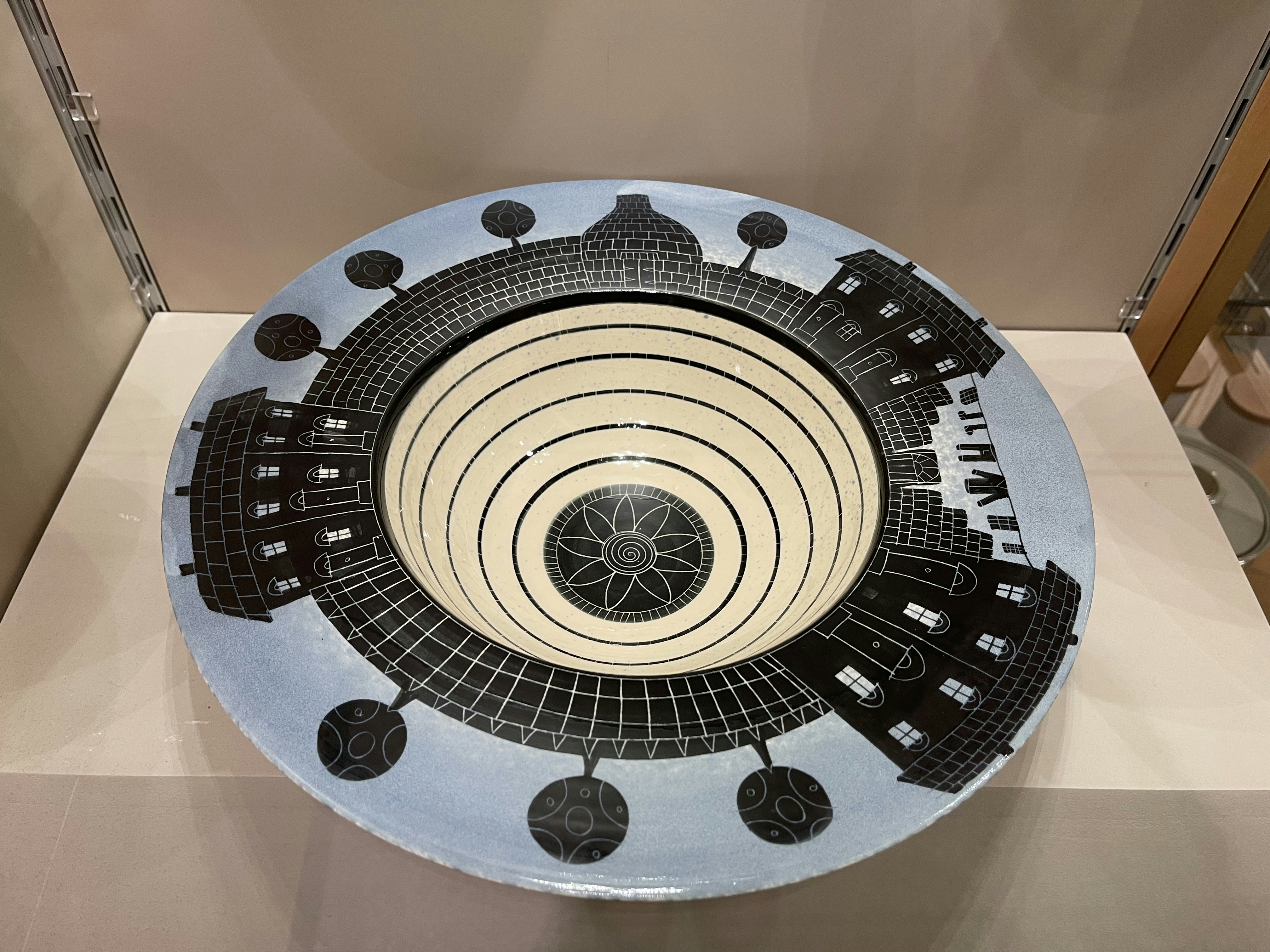 A plate with a picture of a city on it