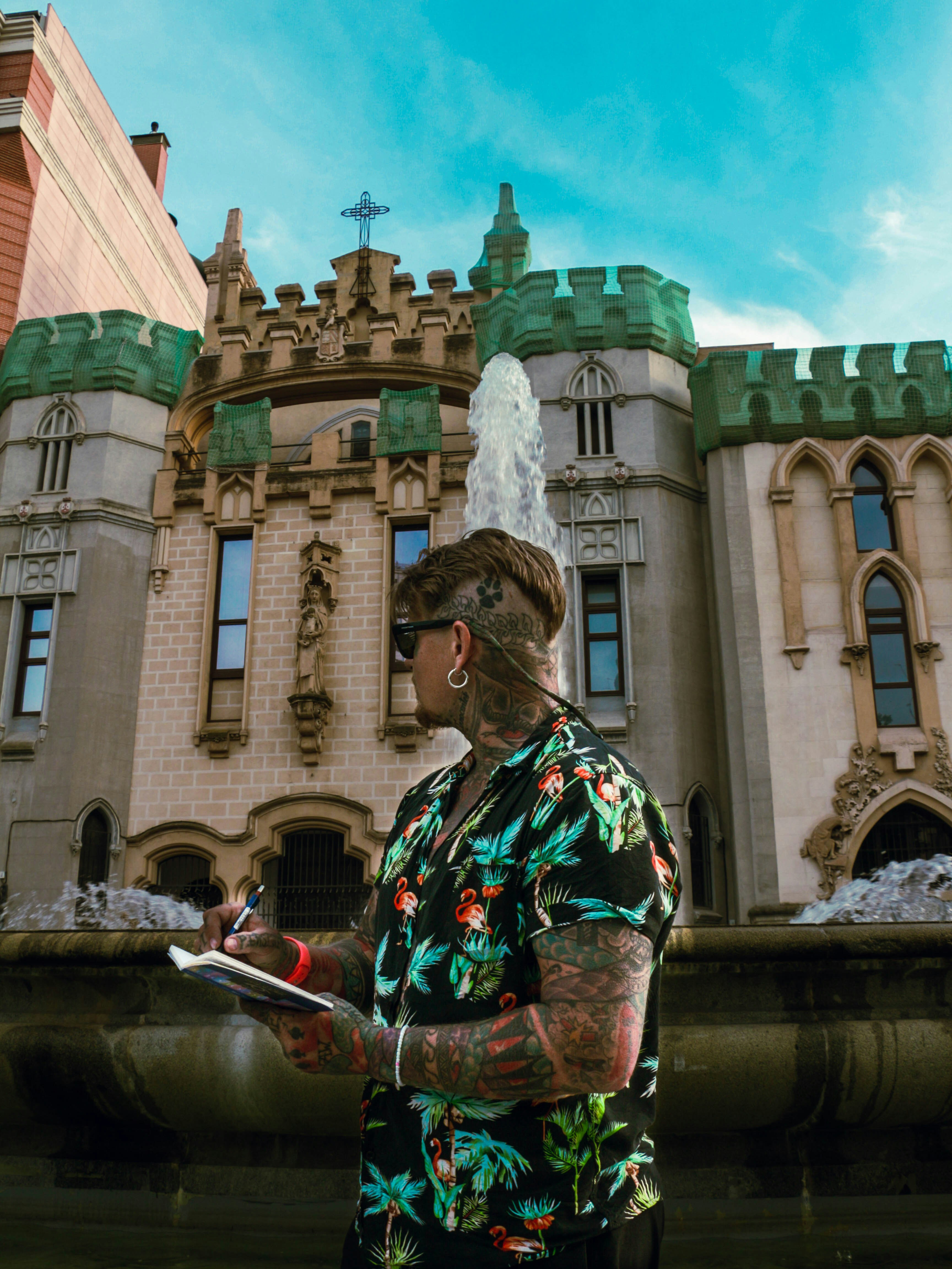 A man standing in front of a fountain in front of a building