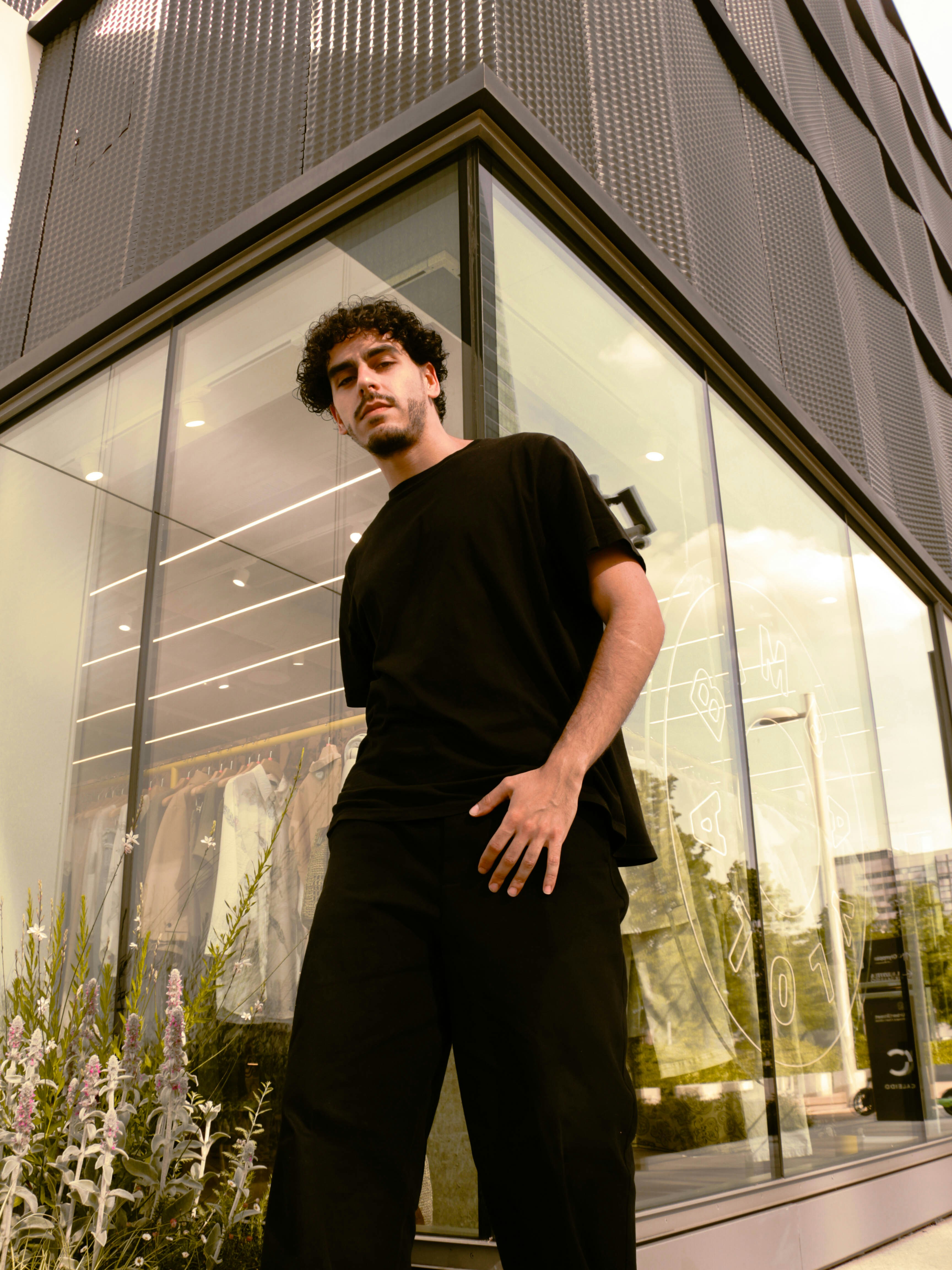 A man standing in front of a tall building