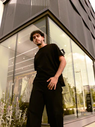 A man standing in front of a tall building