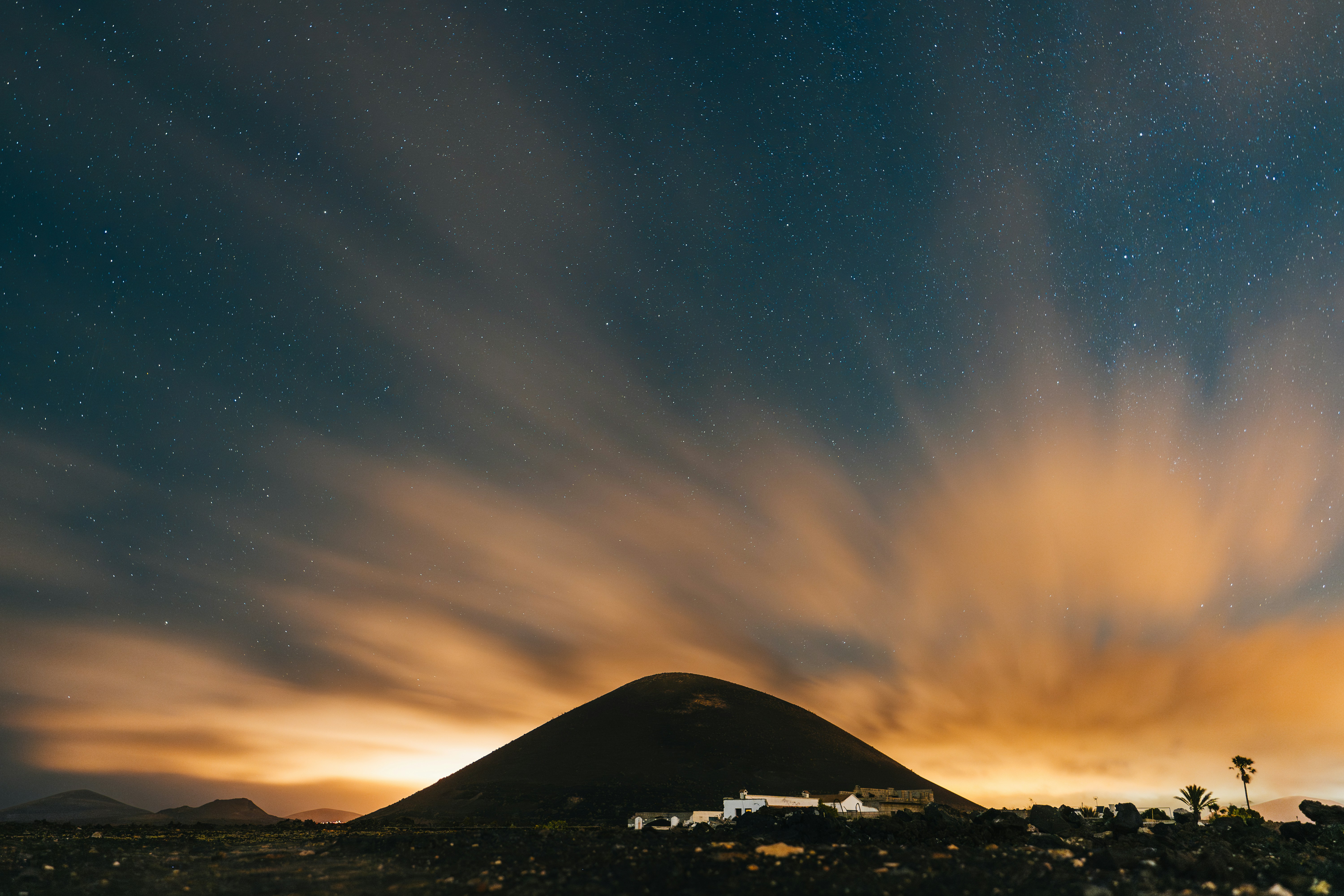 A night sky filled with clouds and stars