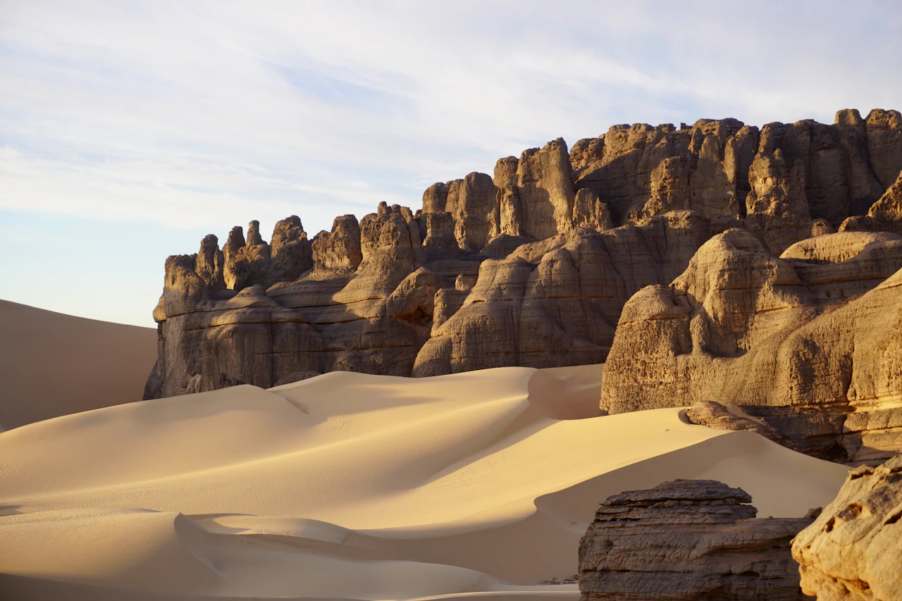 A desert landscape with rocks and sand dunes