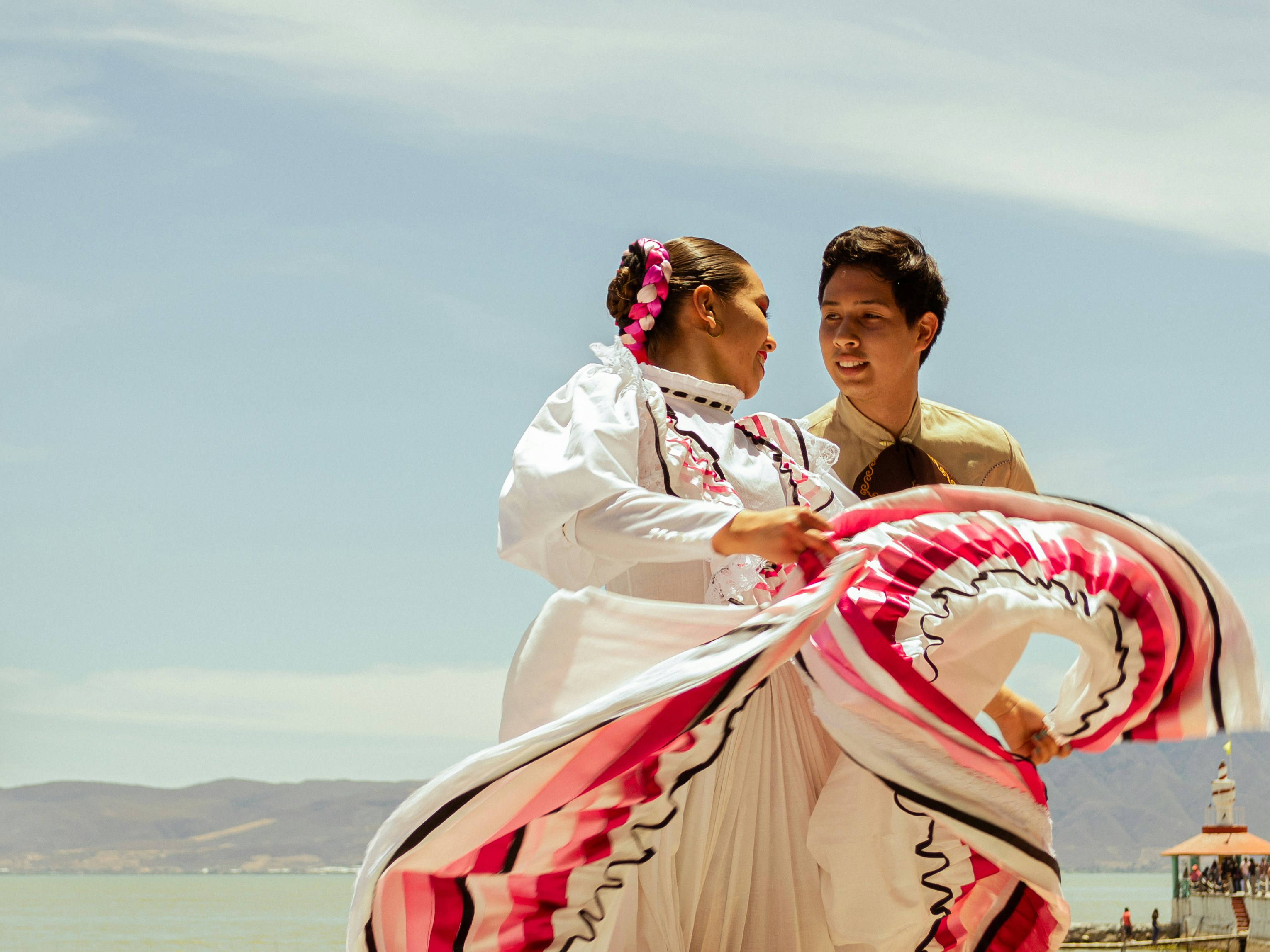 A man and a woman dancing on the beach