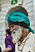 A man with a long beard and a green turban