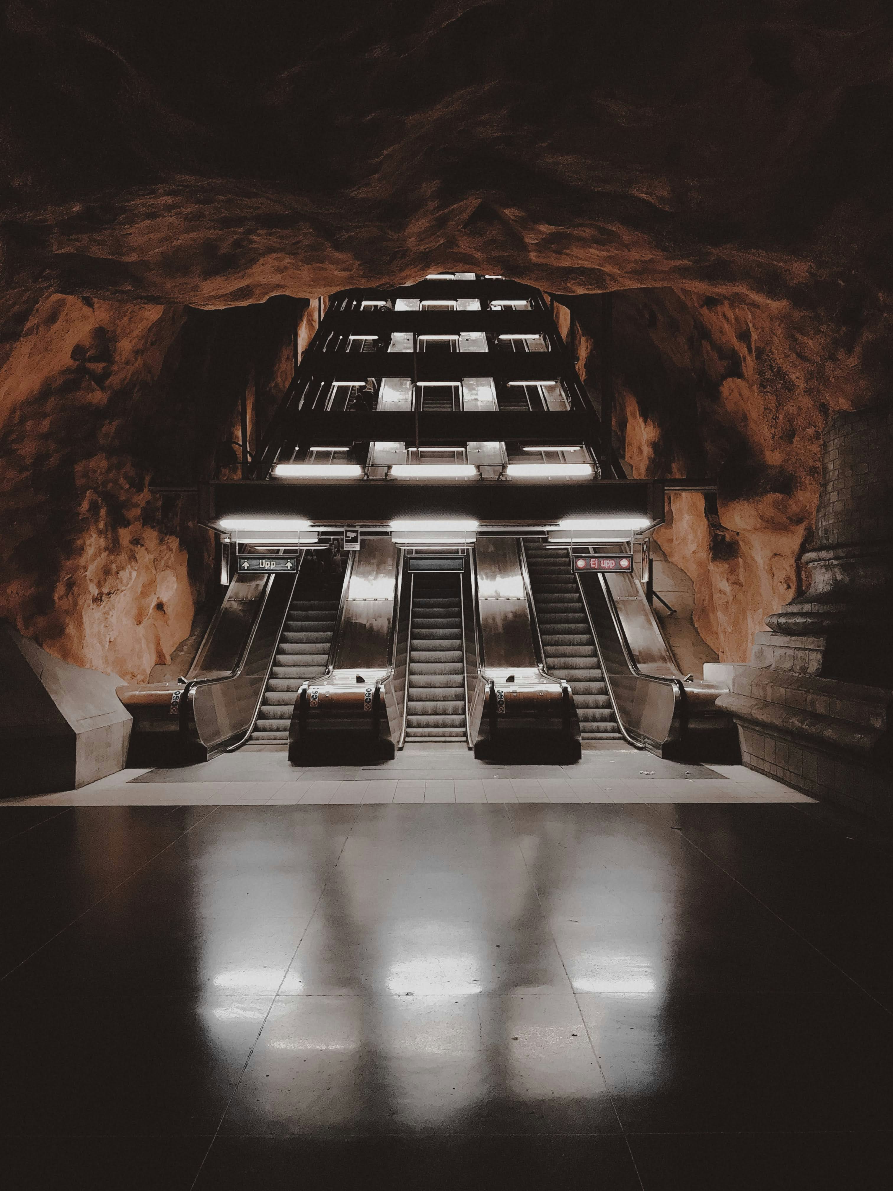 An escalator in a building with a skylight above it