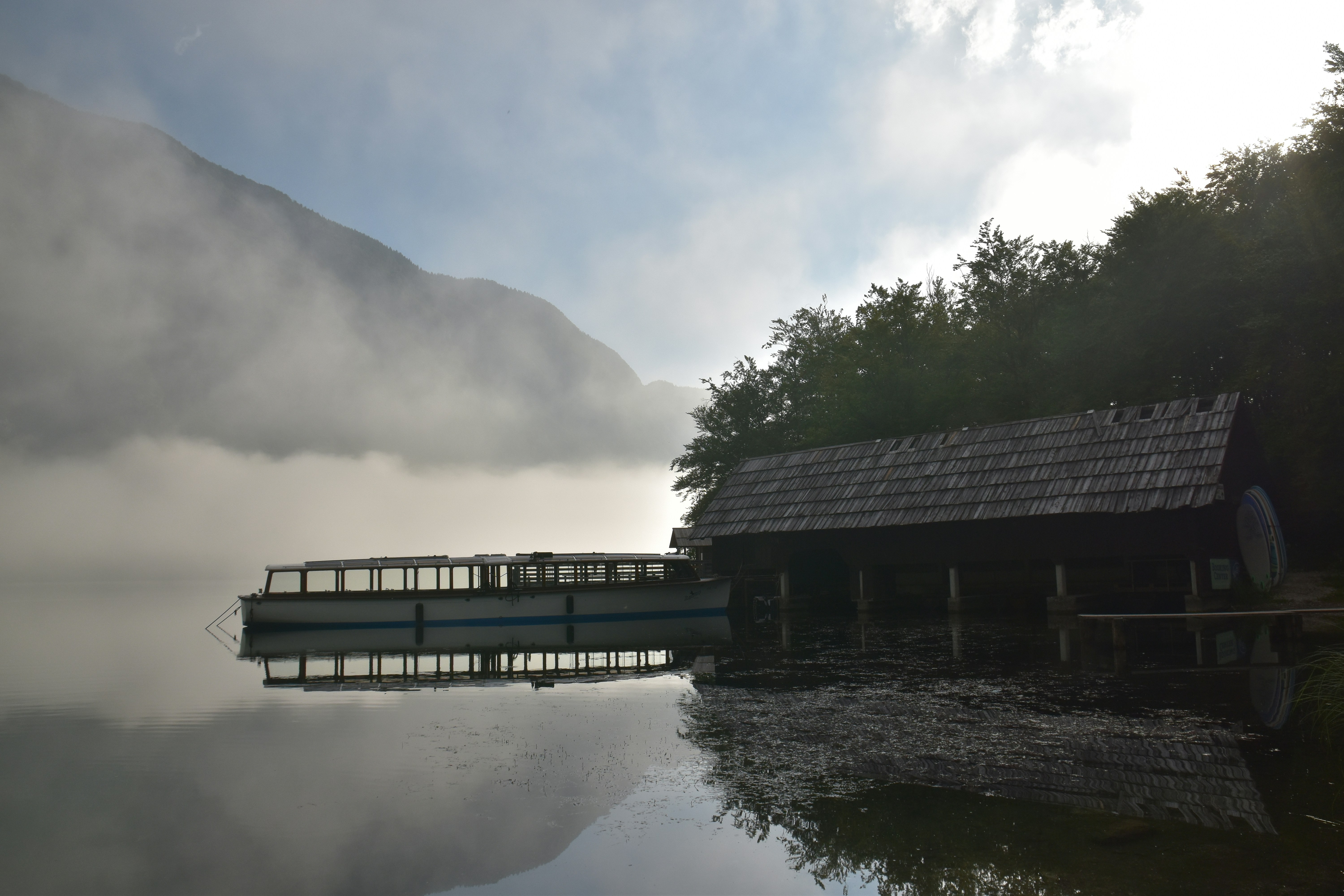 A boat dock on a lake with a mountain in the background