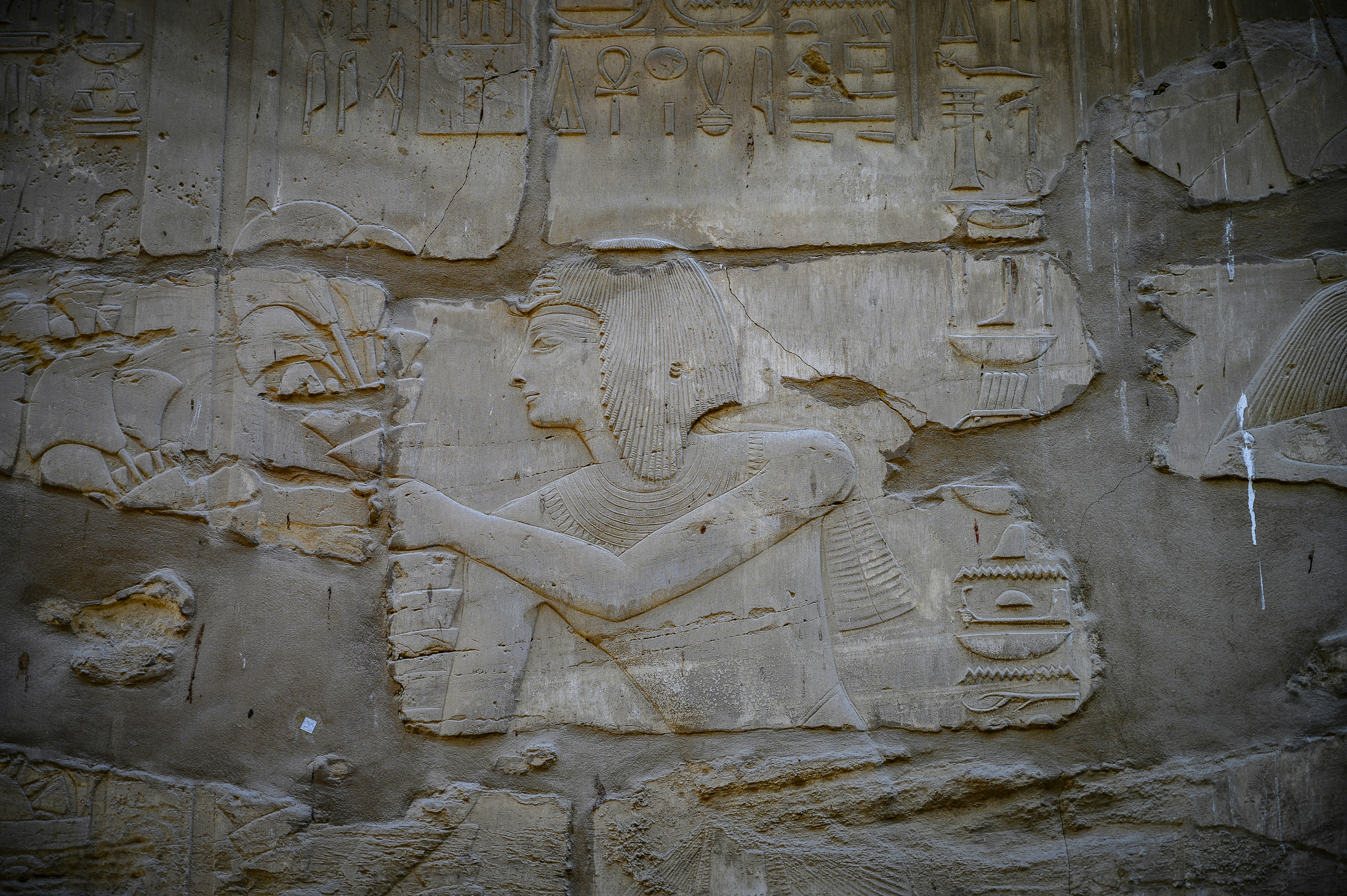 A close up of a stone wall with carvings on it