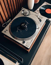 A record player sitting on top of a wooden table