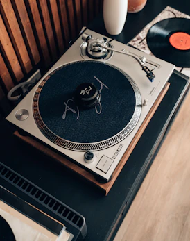 A record player sitting on top of a wooden table