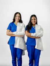 Two women in scrubs standing next to each other