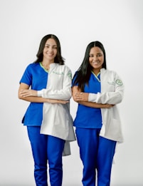 Two women in scrubs standing next to each other