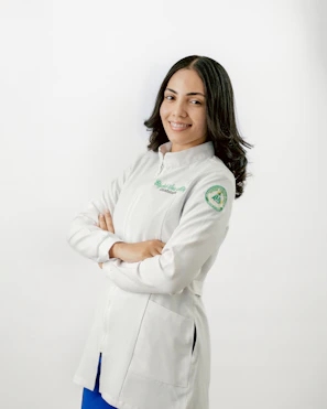 A woman in a white coat is posing for a picture
