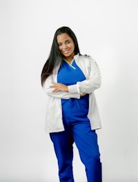 A woman in scrubs posing for a picture