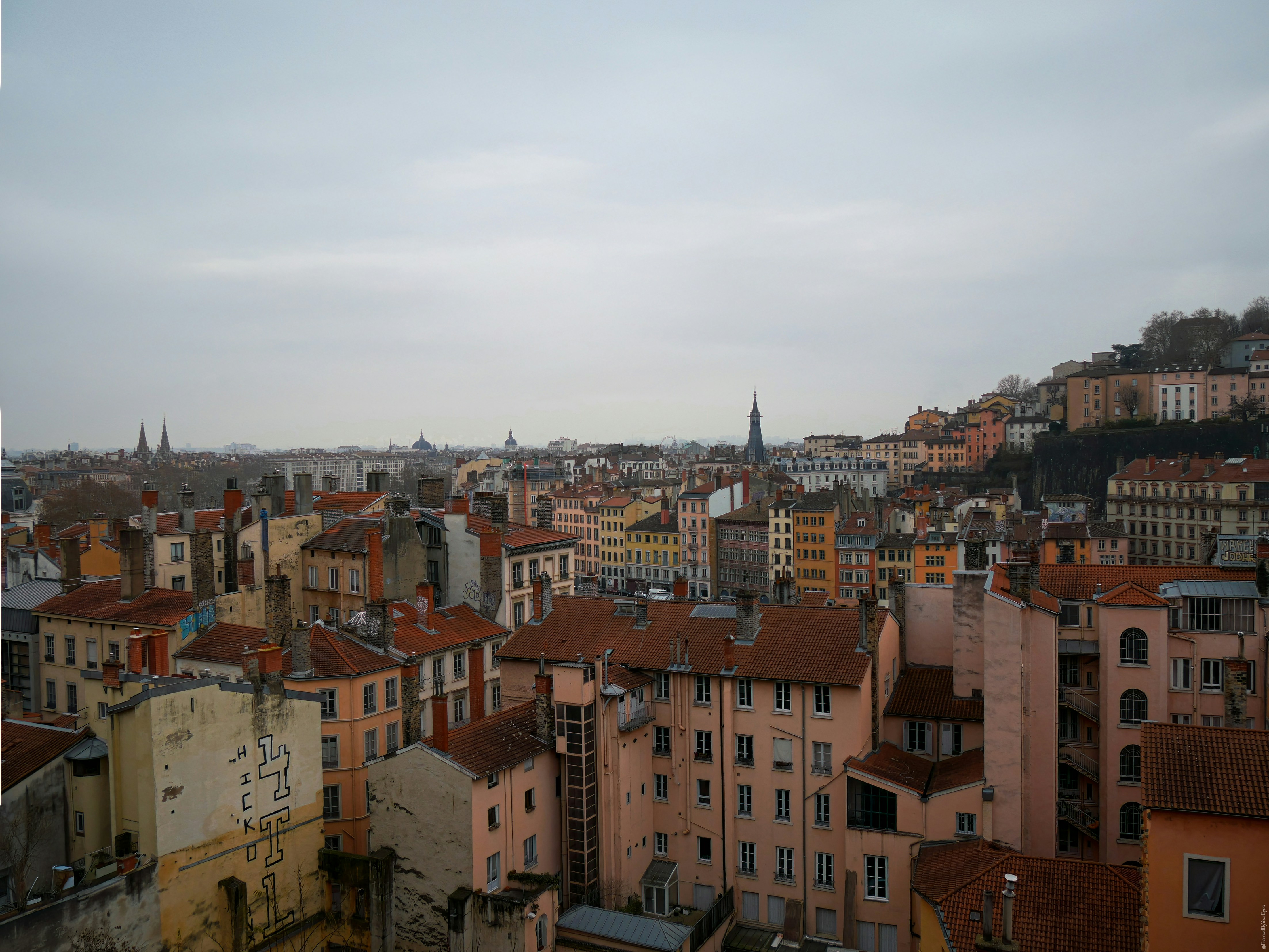 A view of a city from the top of a hill