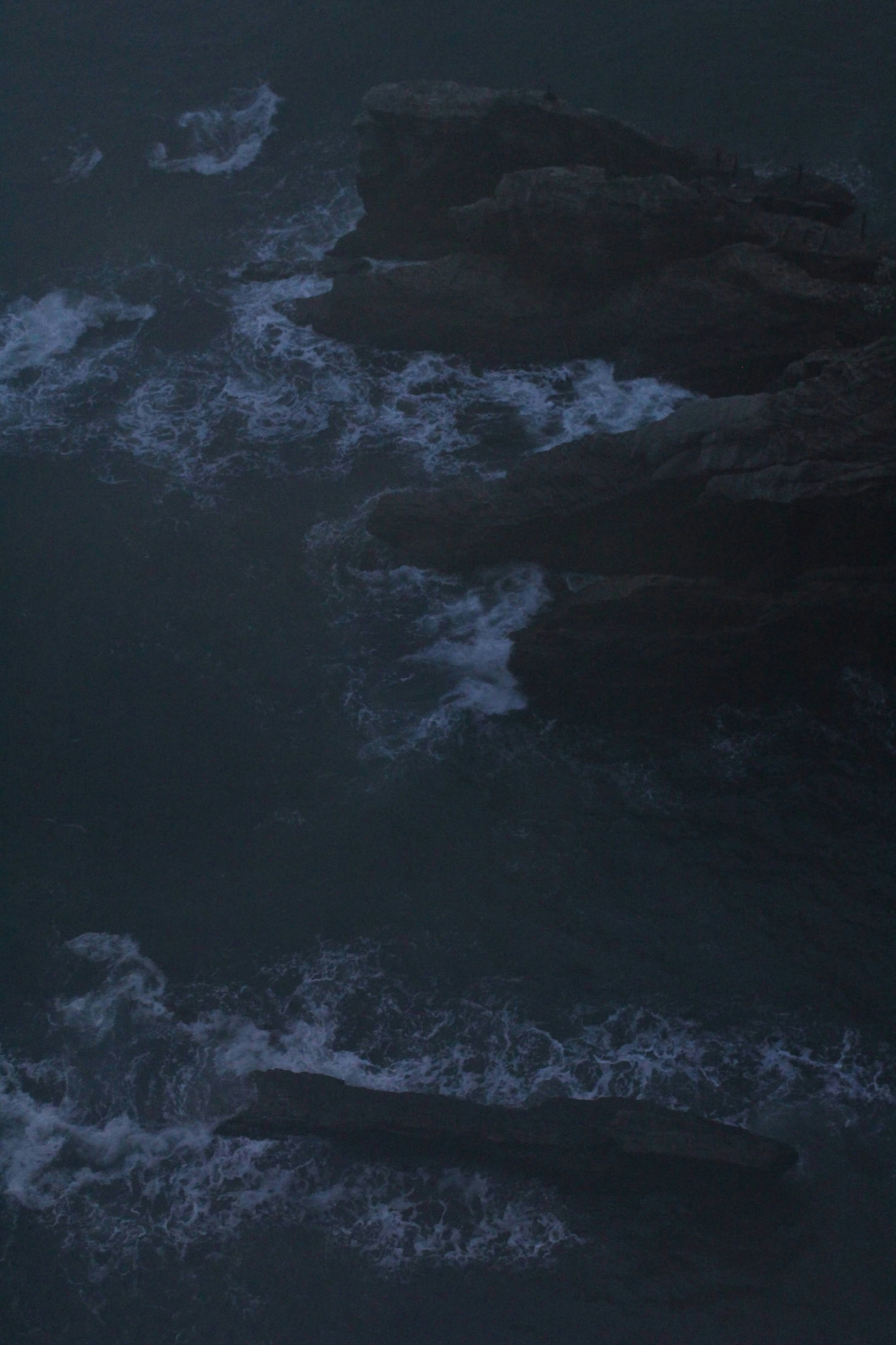 A large body of water surrounded by rocks