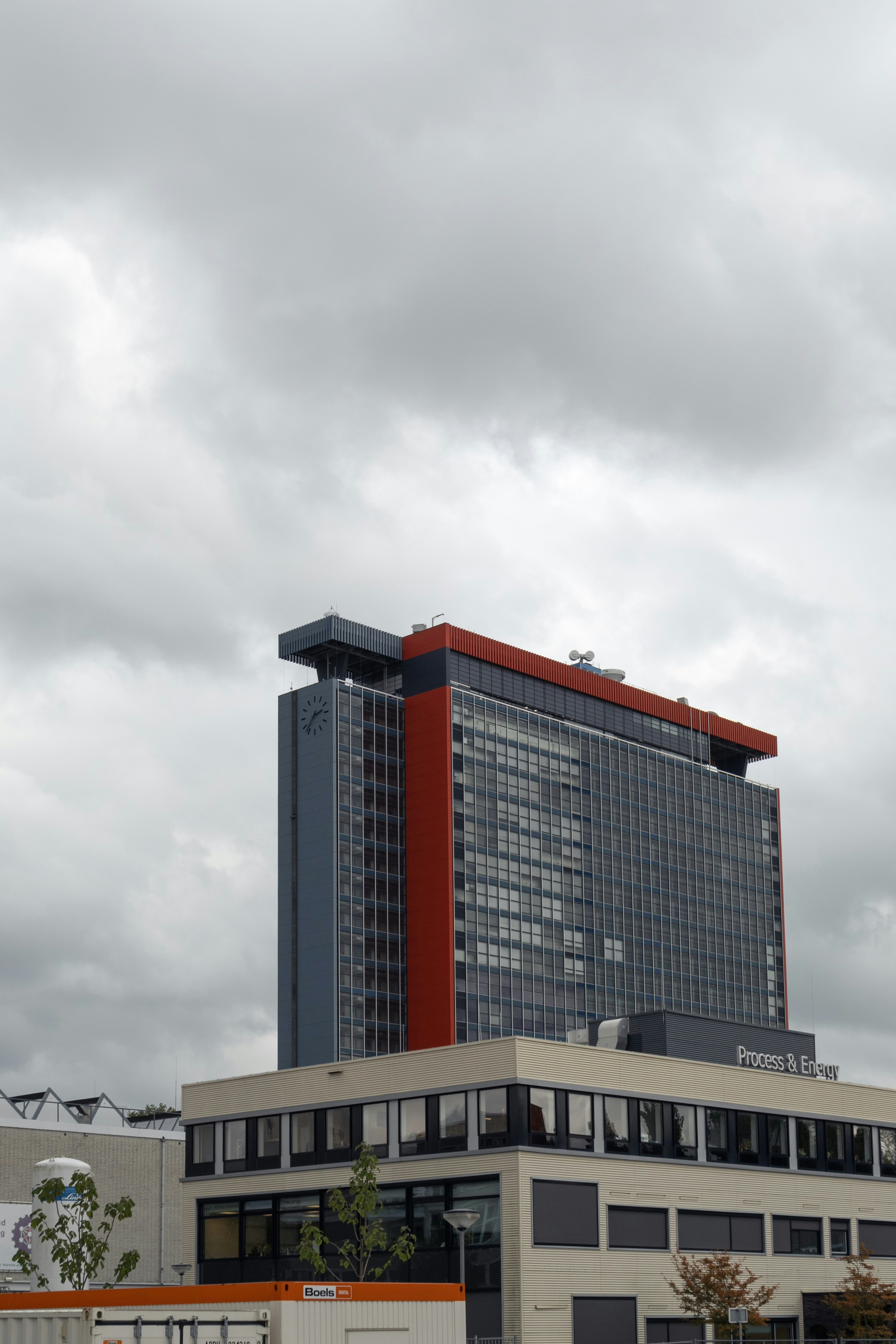 A tall building with a red and black top