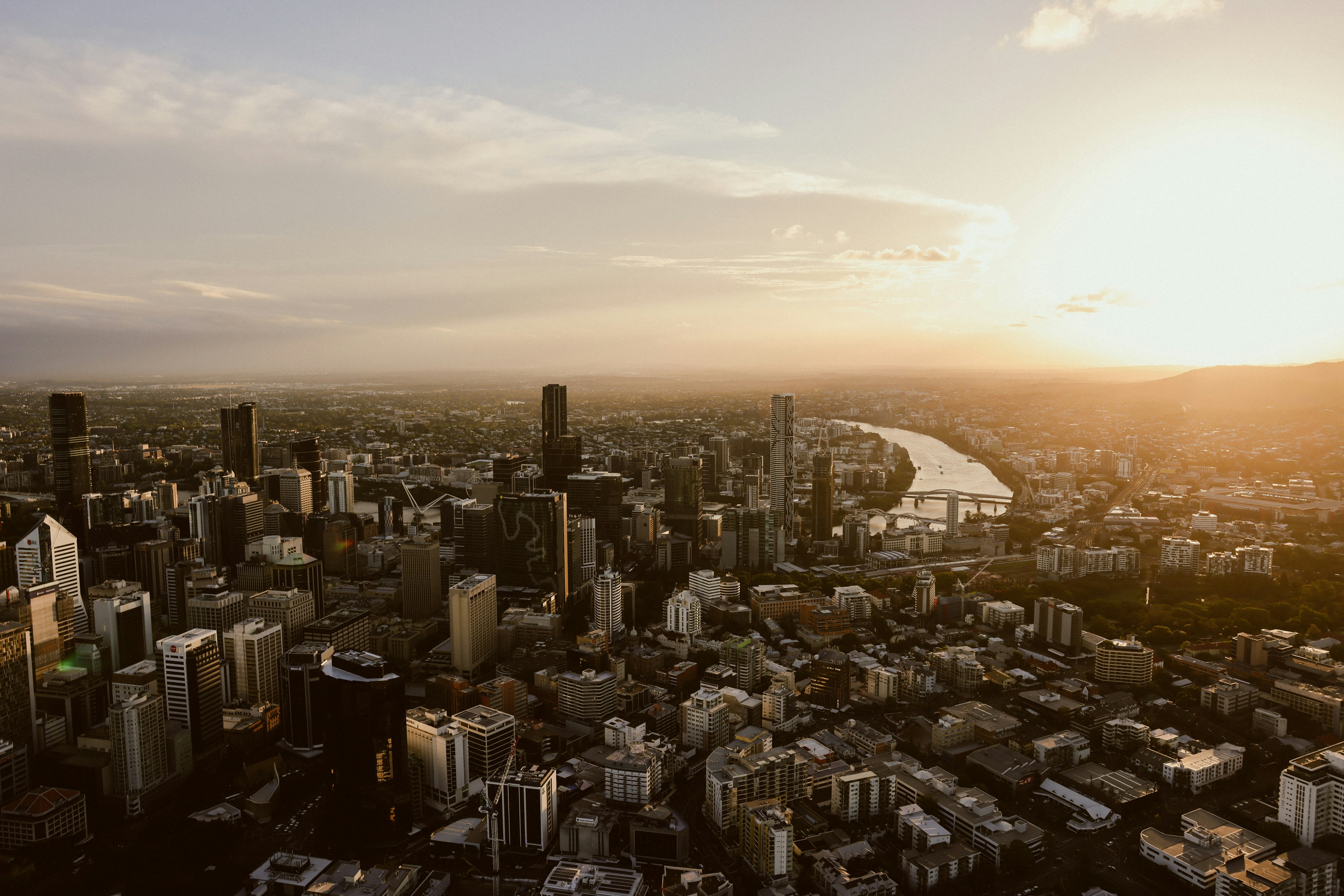An aerial view of a city at sunset, Arial helicopter shot of Brisbane City at sunset 2025 summer.