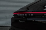A black porsche parked in front of a tire shop in Nigeria