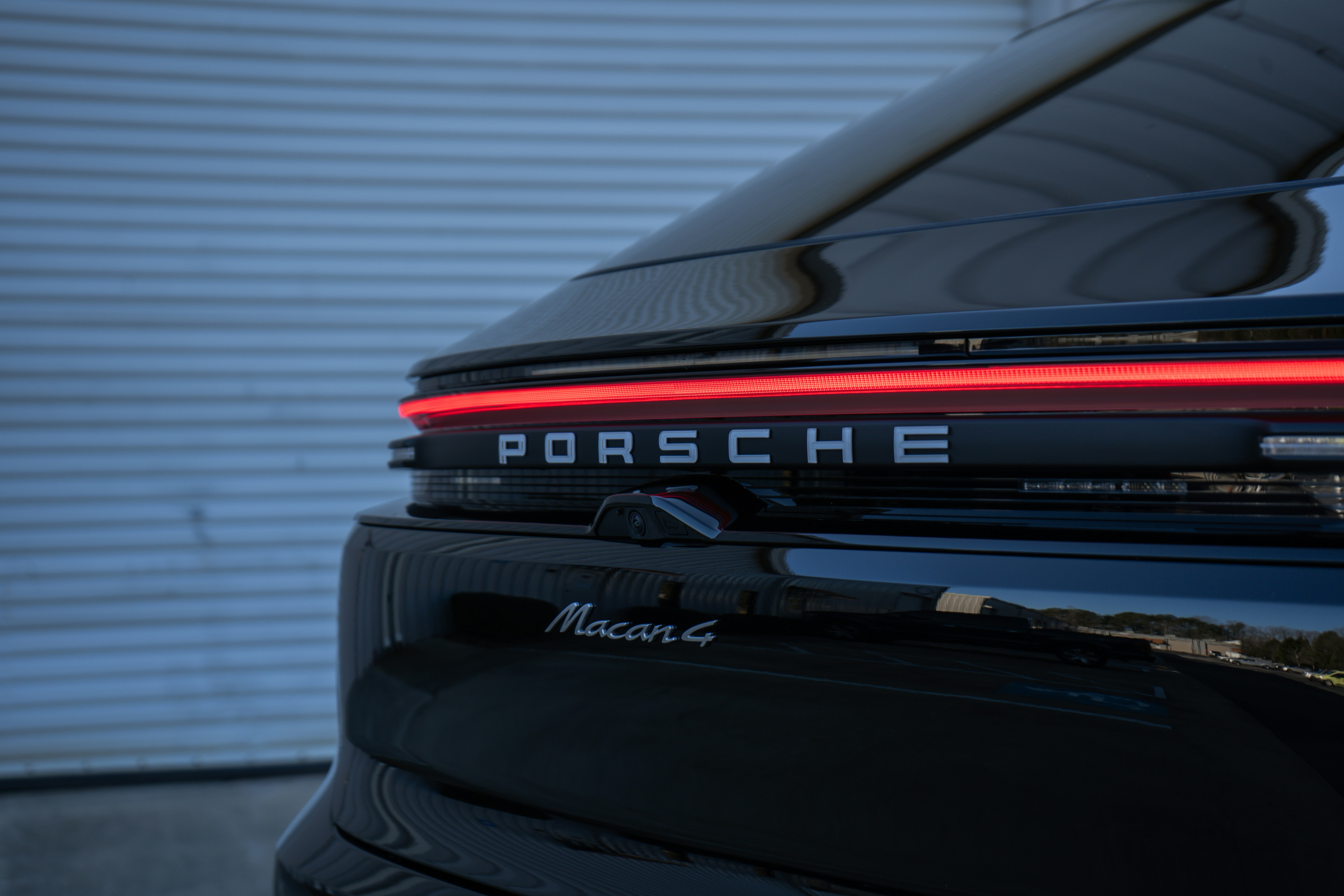 A close up of a porsche logo on a car