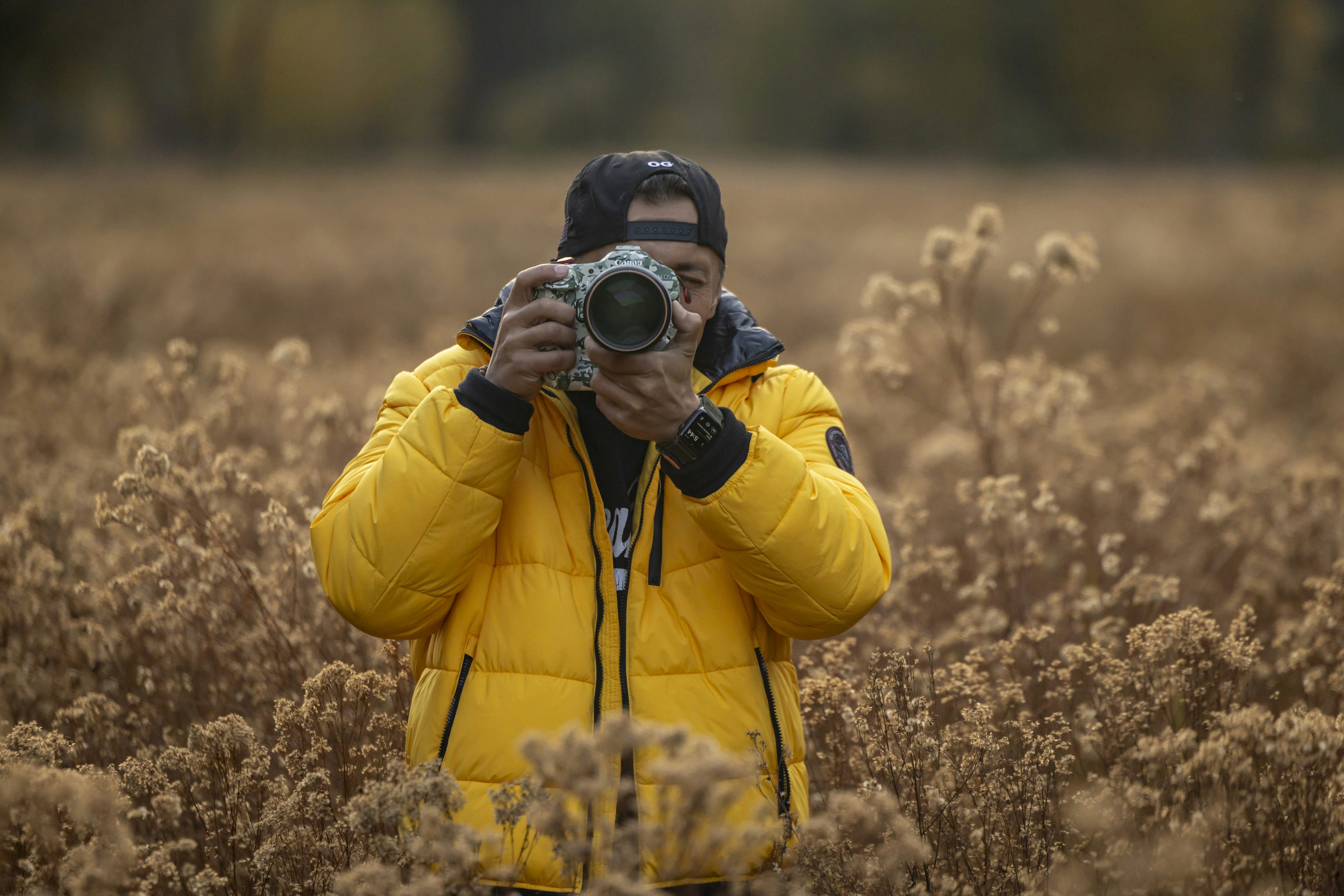 A man taking a picture of himself in a field