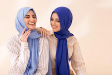 Two women in hijabs standing next to each other