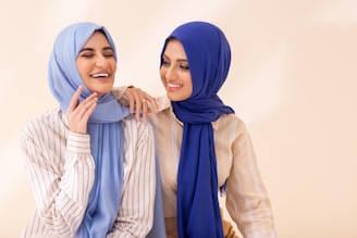 Two women in hijabs standing next to each other