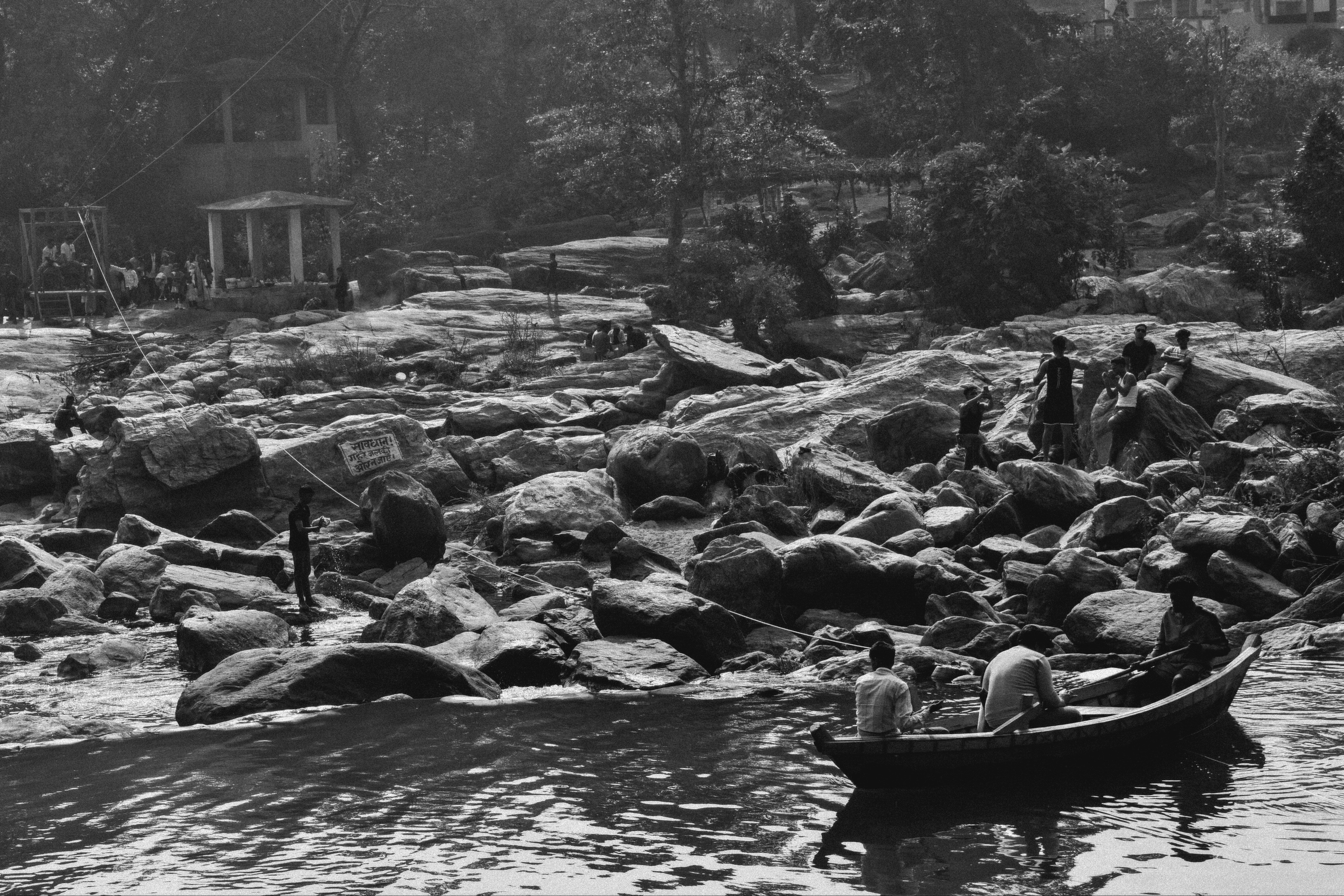 A black and white photo of people in a boat