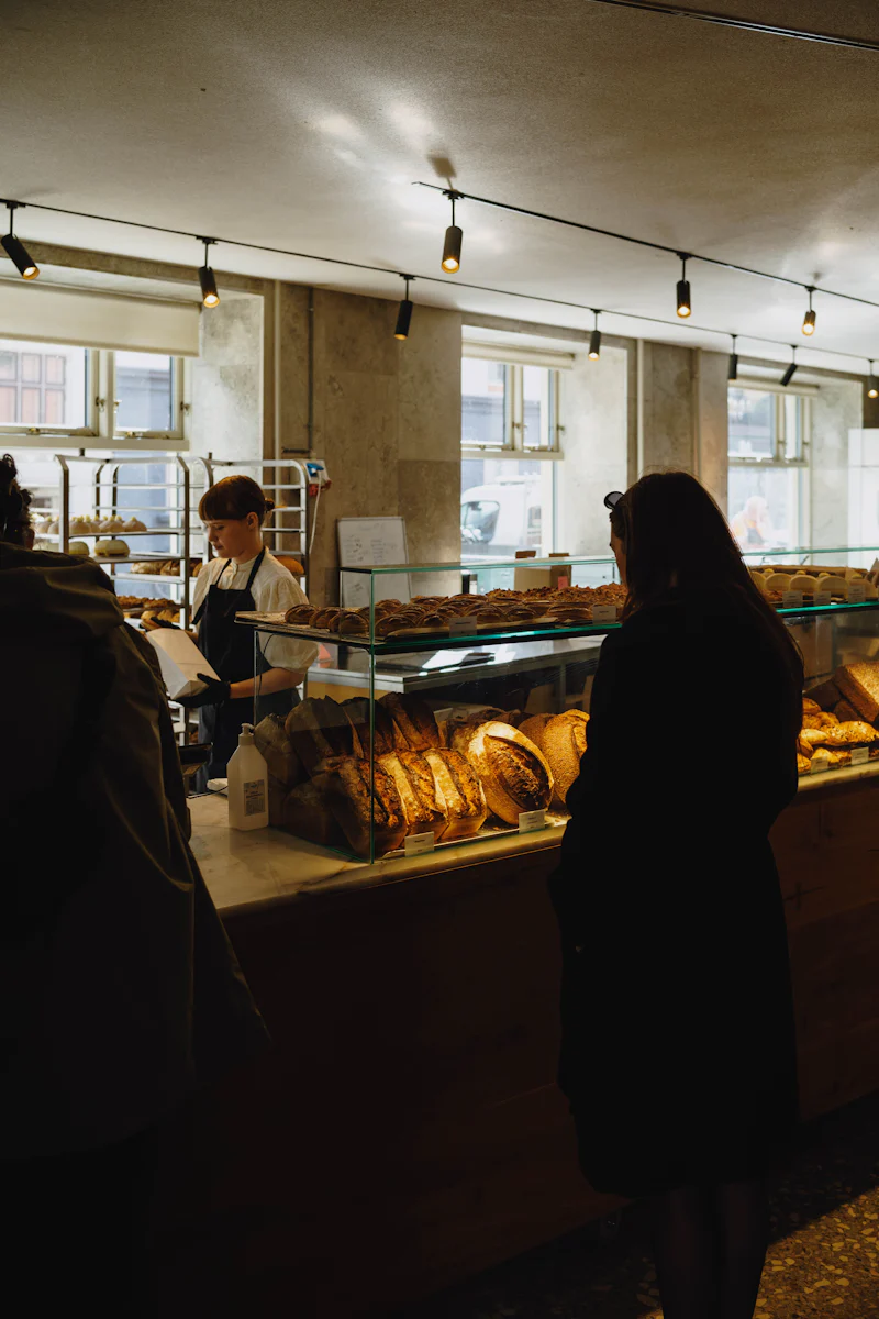 Woman behind the bread counter of her bakery