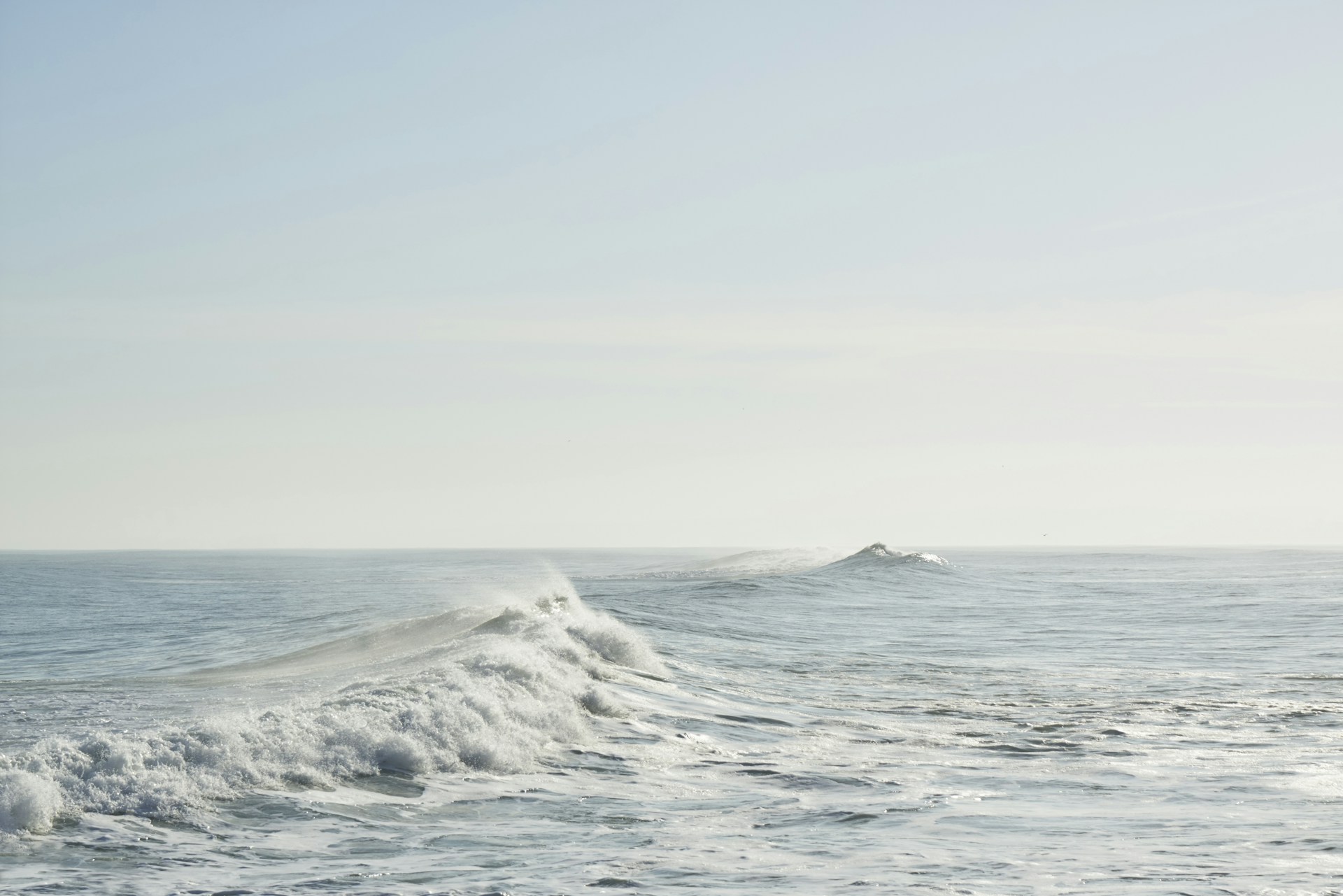 A person riding a surfboard on a wave in the ocean