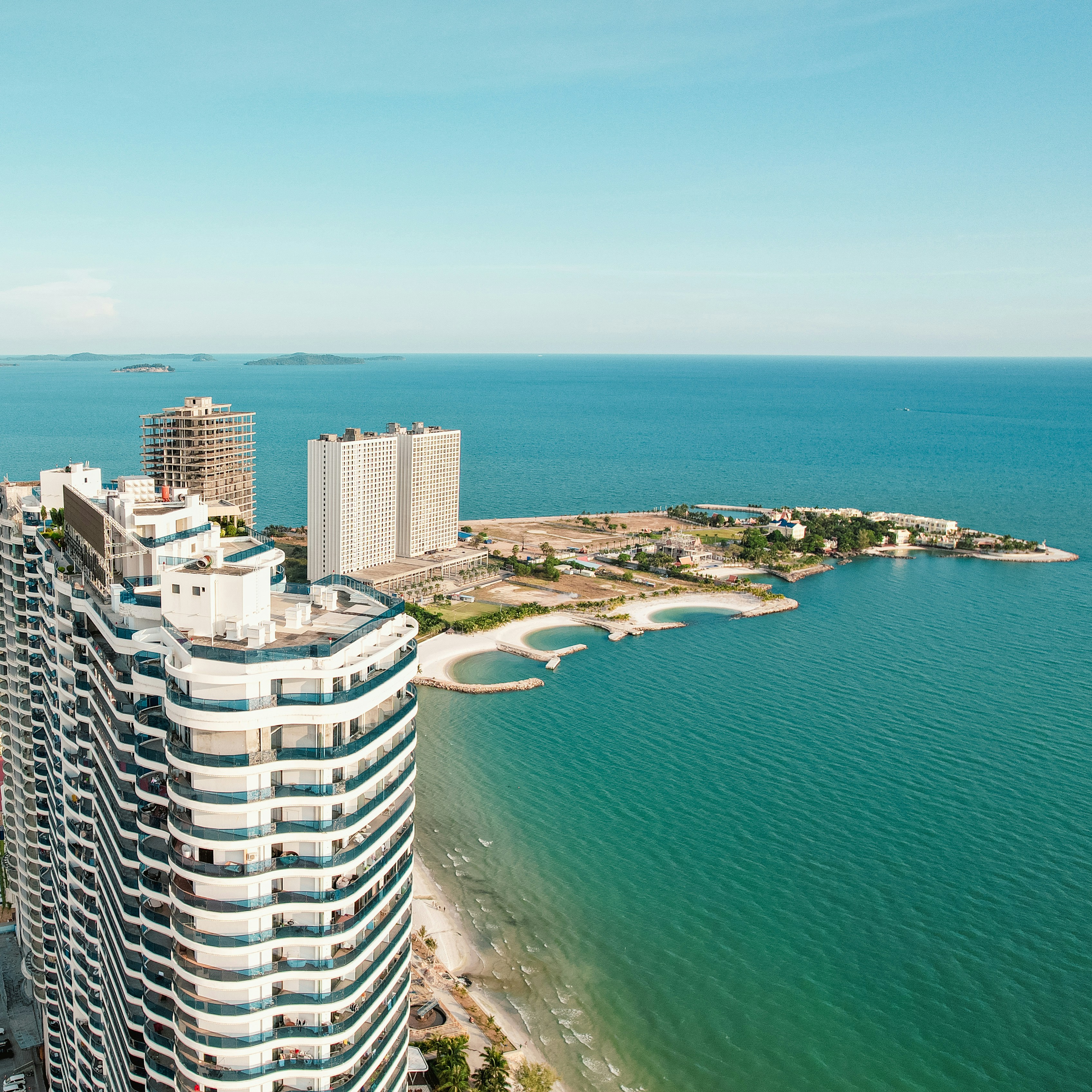 An aerial view of a high rise building next to the ocean