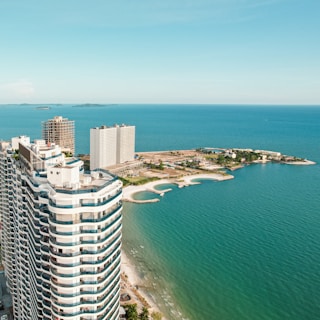 An aerial view of a high rise building next to the ocean
