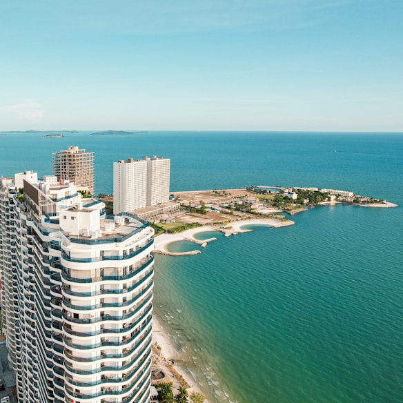 An aerial view of a high rise building next to the ocean