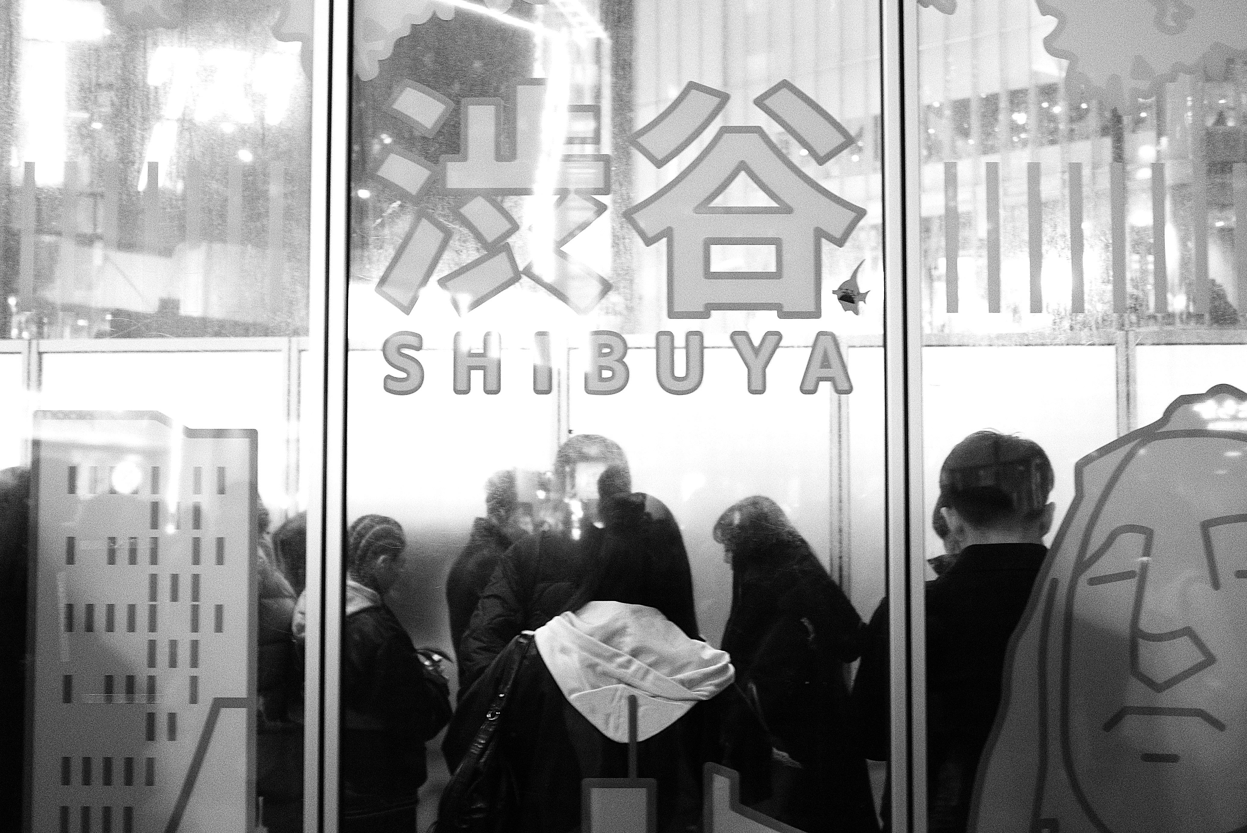 A group of people standing outside of a building