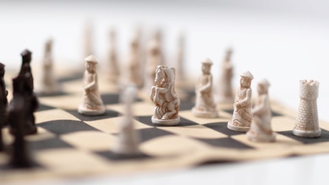 A close up of a chess board with pieces on it