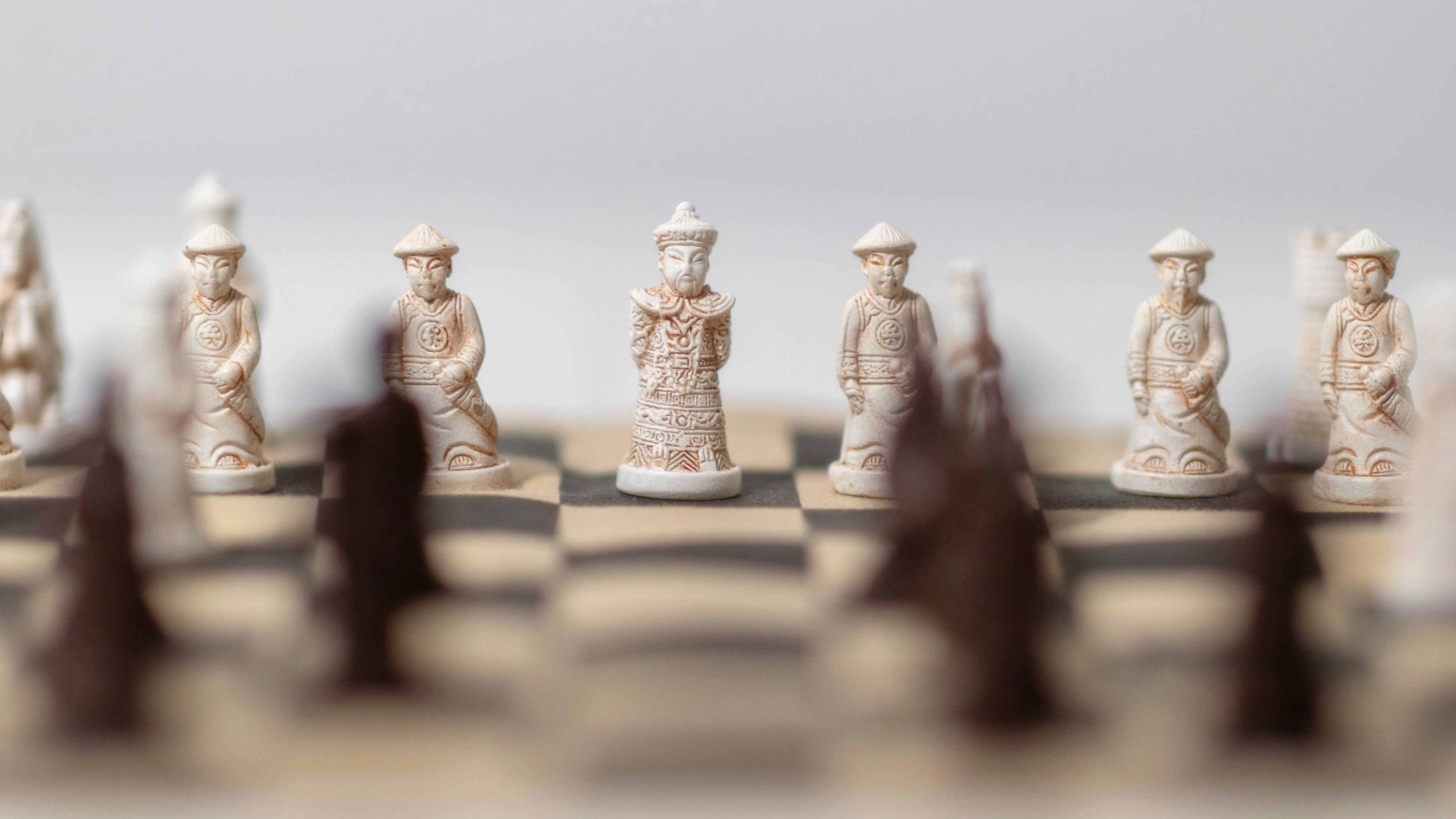 A close up of a chess board with figures on it