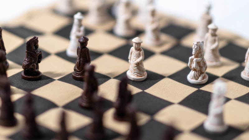 Close-up black and white chess board with two pieces in a late endgame position