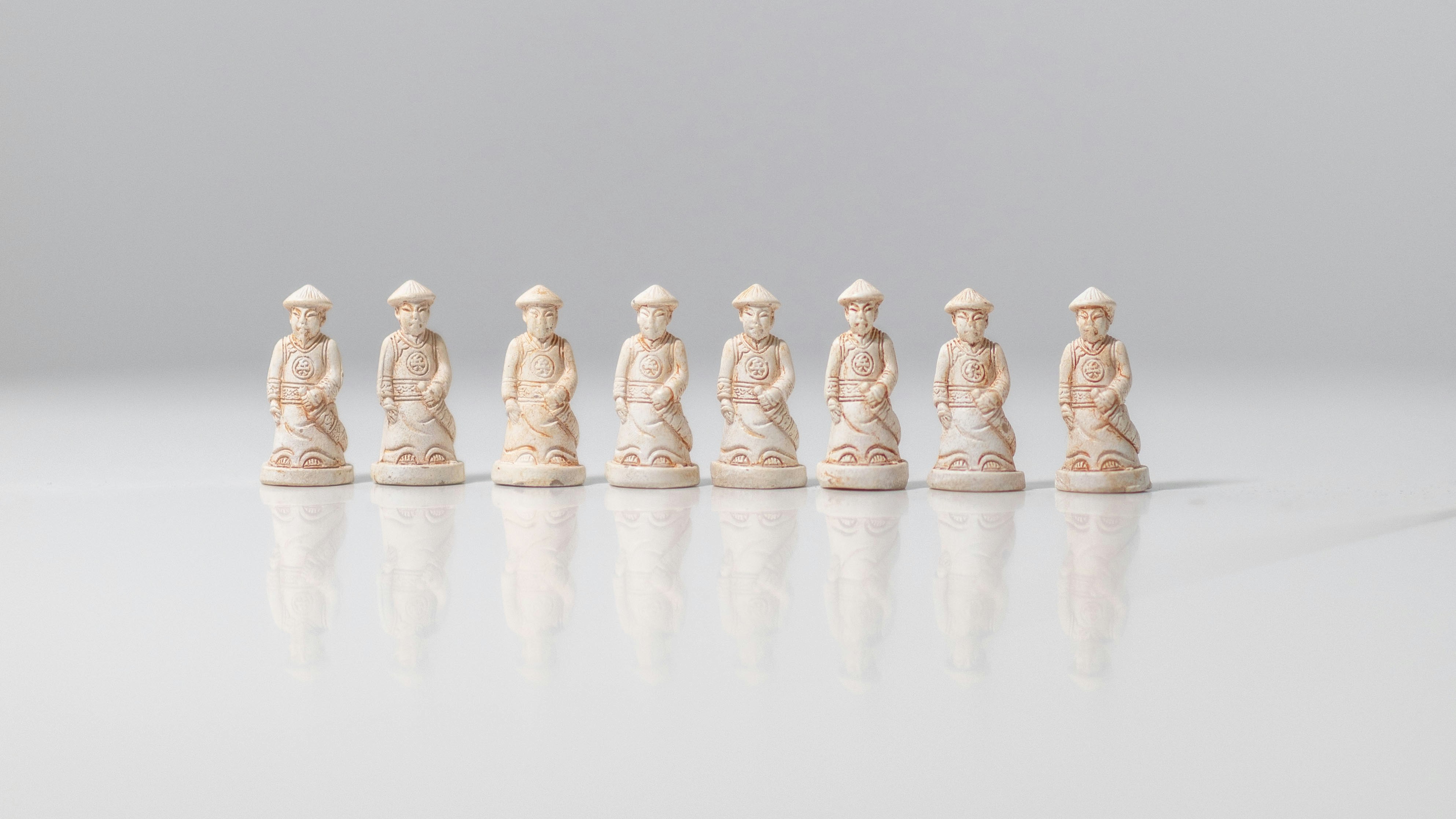 A group of white chess pieces sitting on top of a table