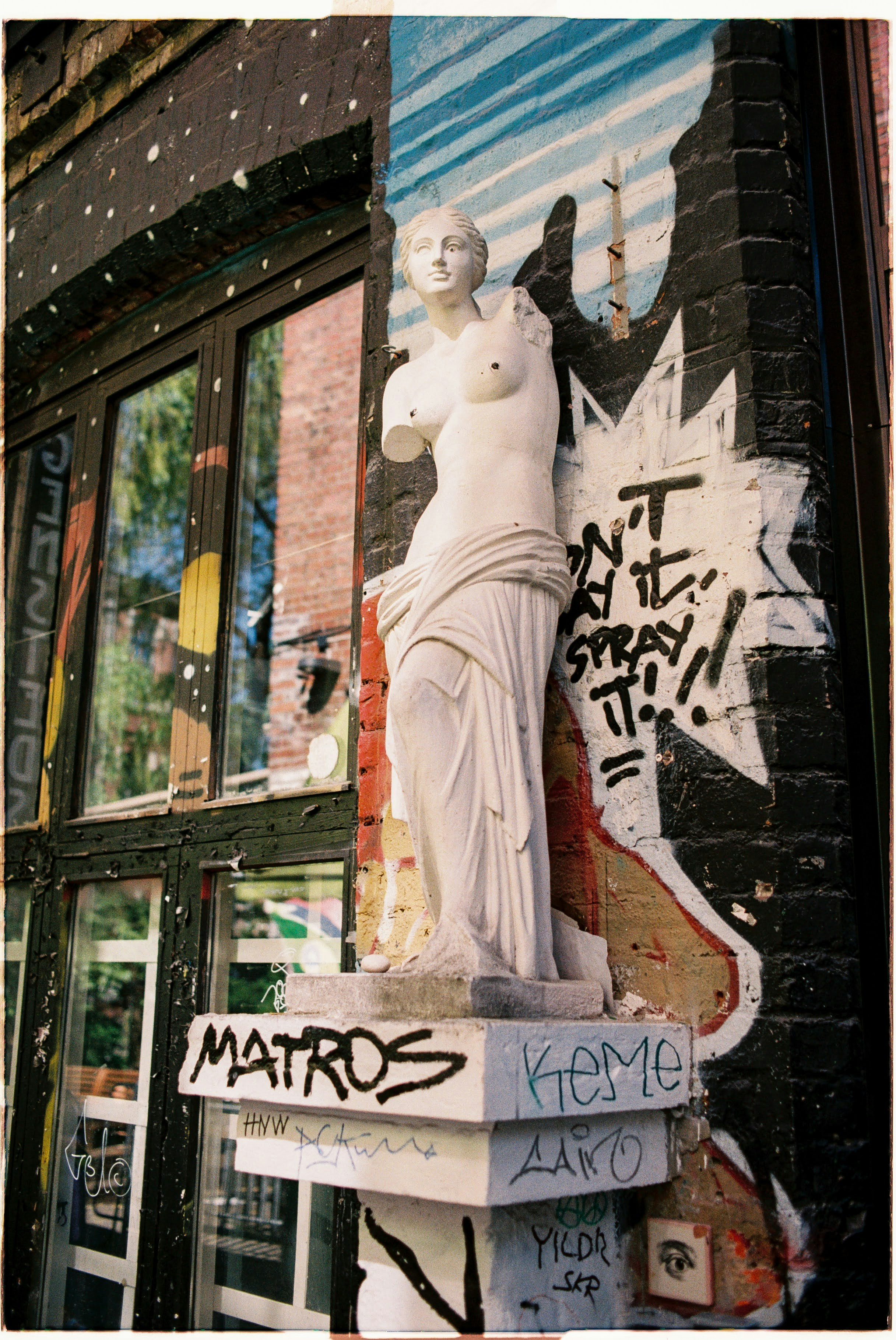 A statue of a woman standing on top of a box