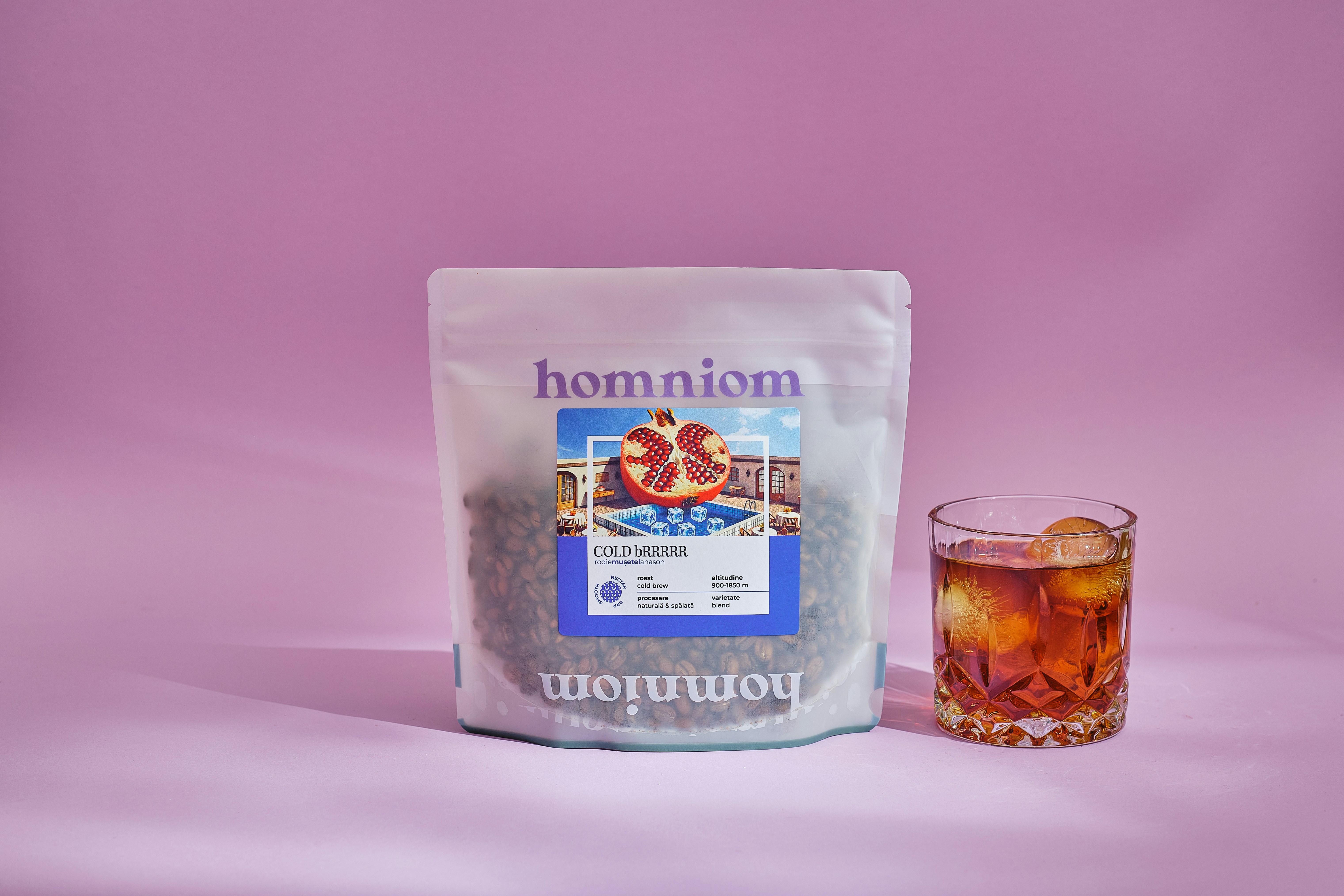 A bag of tea next to a glass of tea