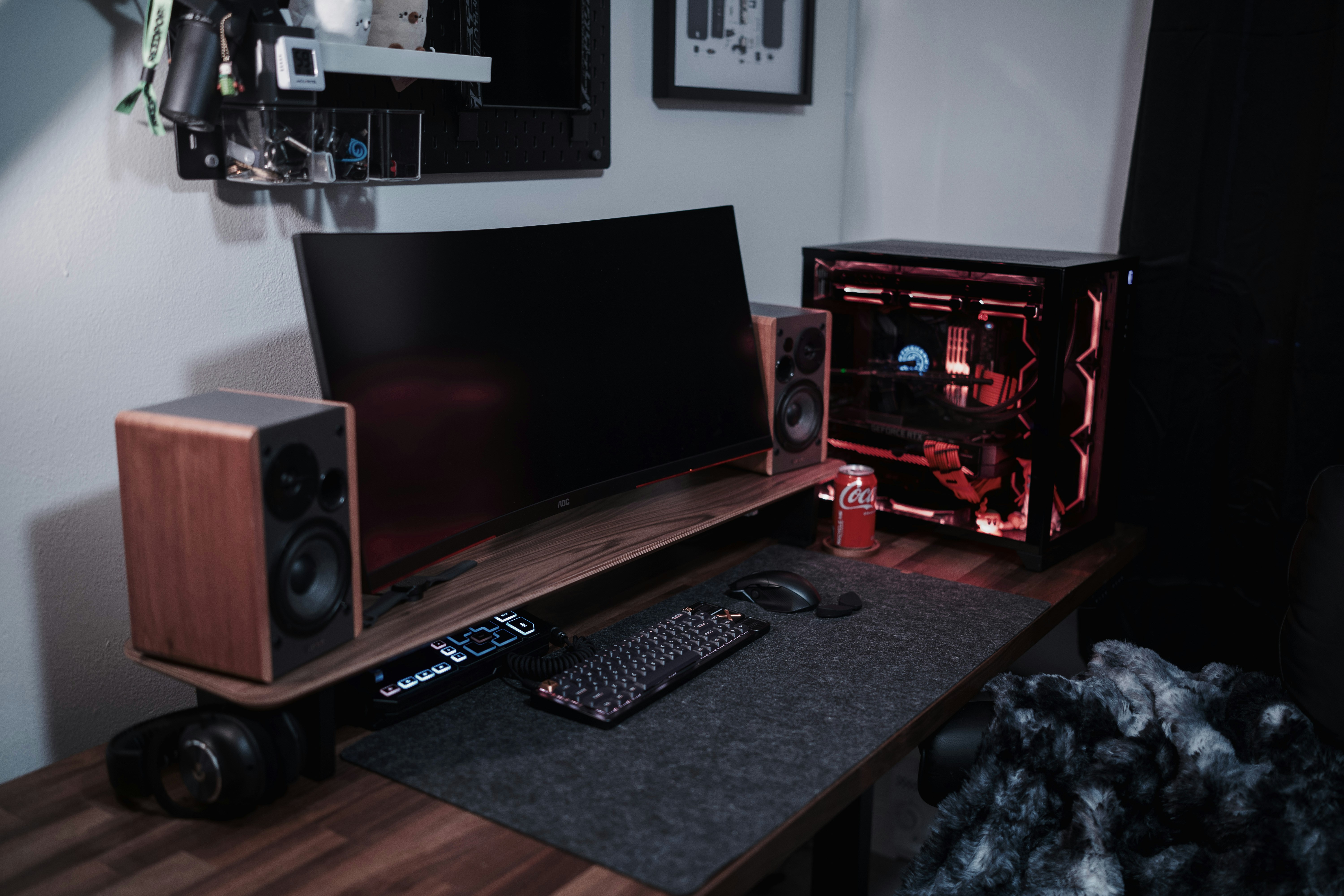 A desk with a laptop and speakers on it
