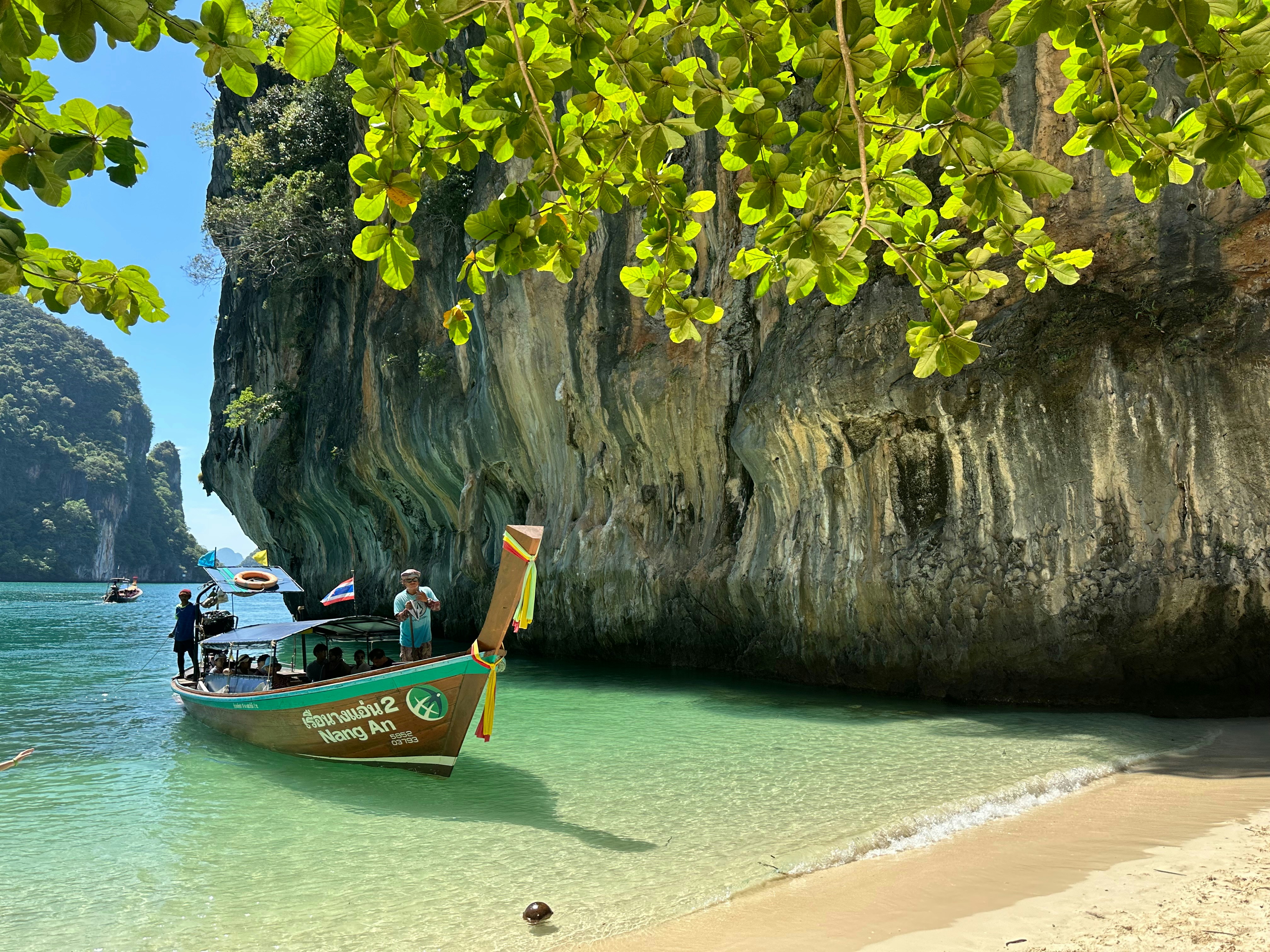 A boat on a beach near a cliff, 🇹🇭
