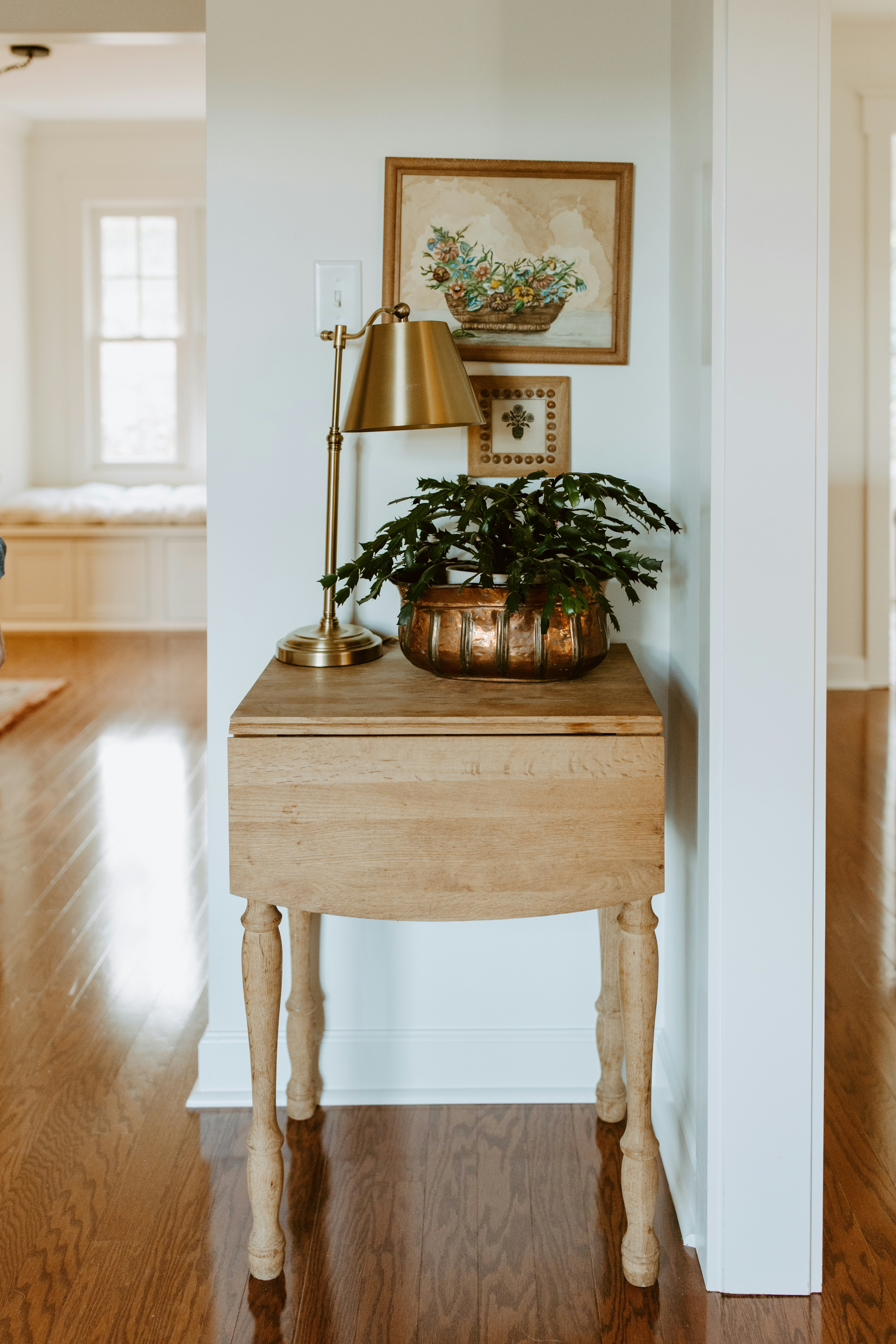 A wooden table with a plant on top of it