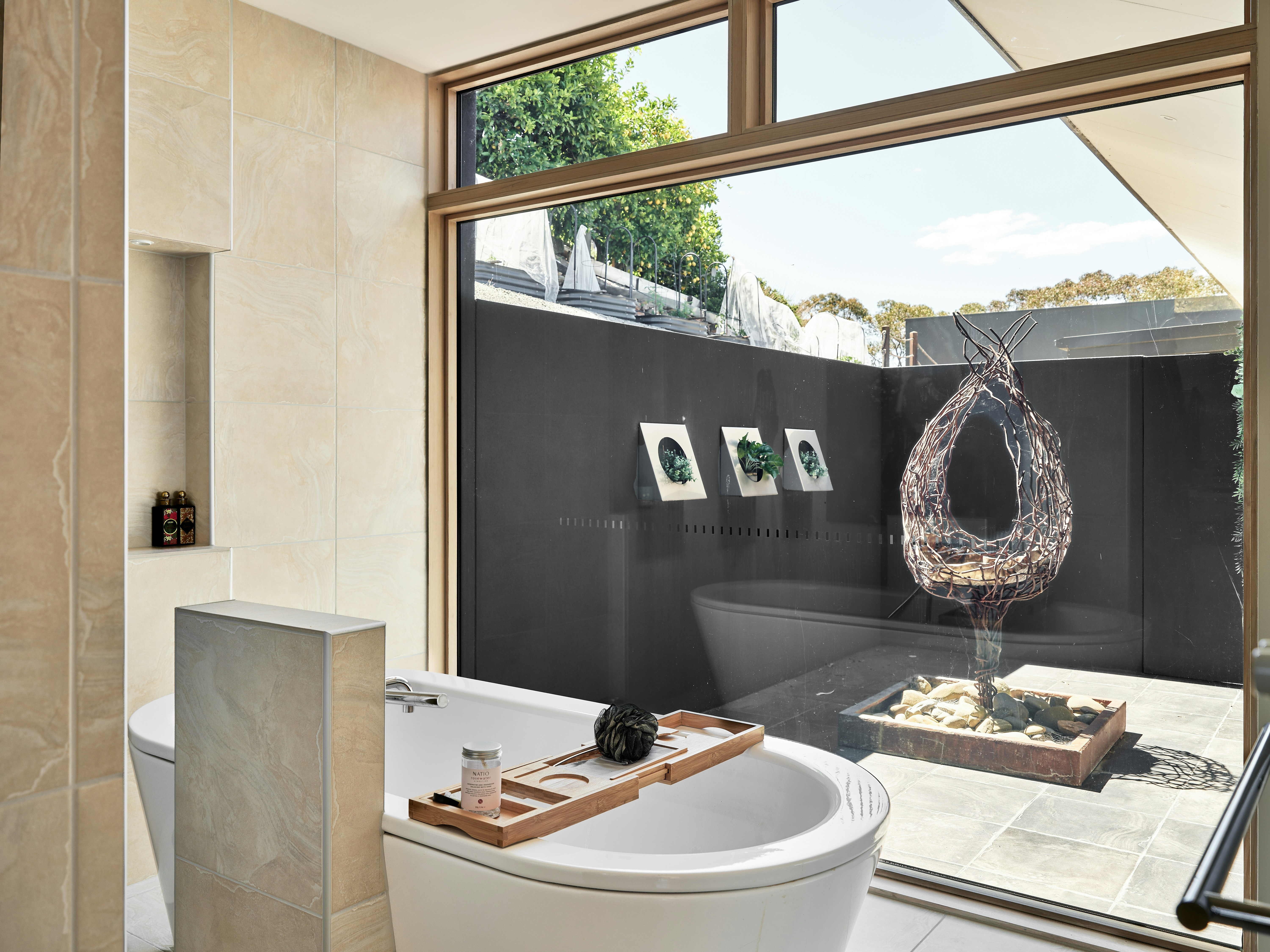 A bathroom with a large window and a white toilet