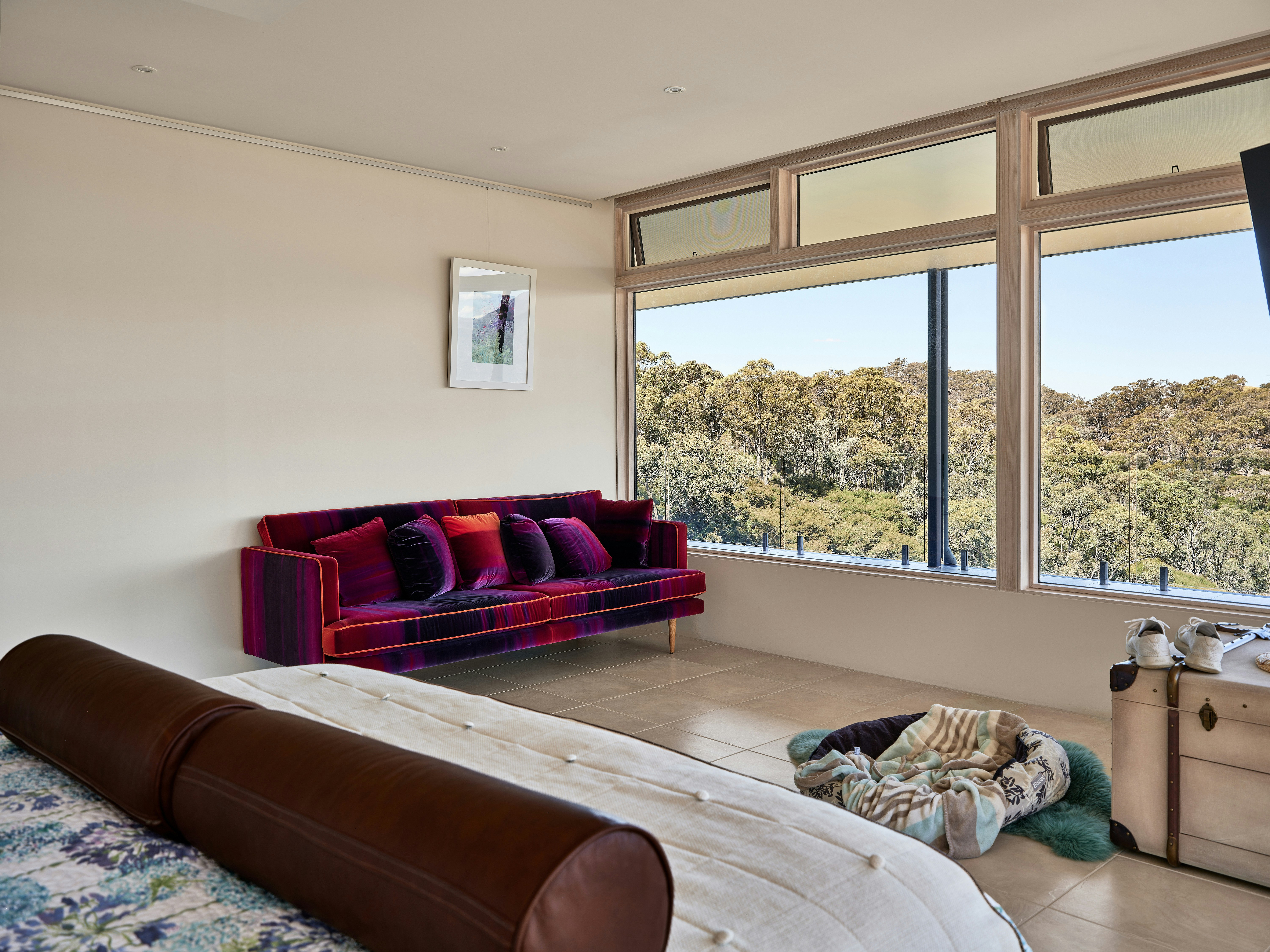A bedroom with a large bed and a large window
