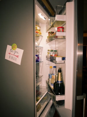 A refrigerator with its door open and food in it